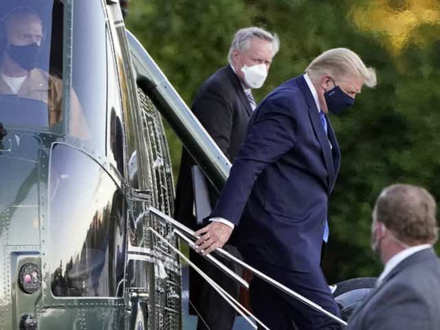 Donald Trump, seen here arriving at Walter Reed military hospital on Friday, says he will return to the White House on Monday evening. 