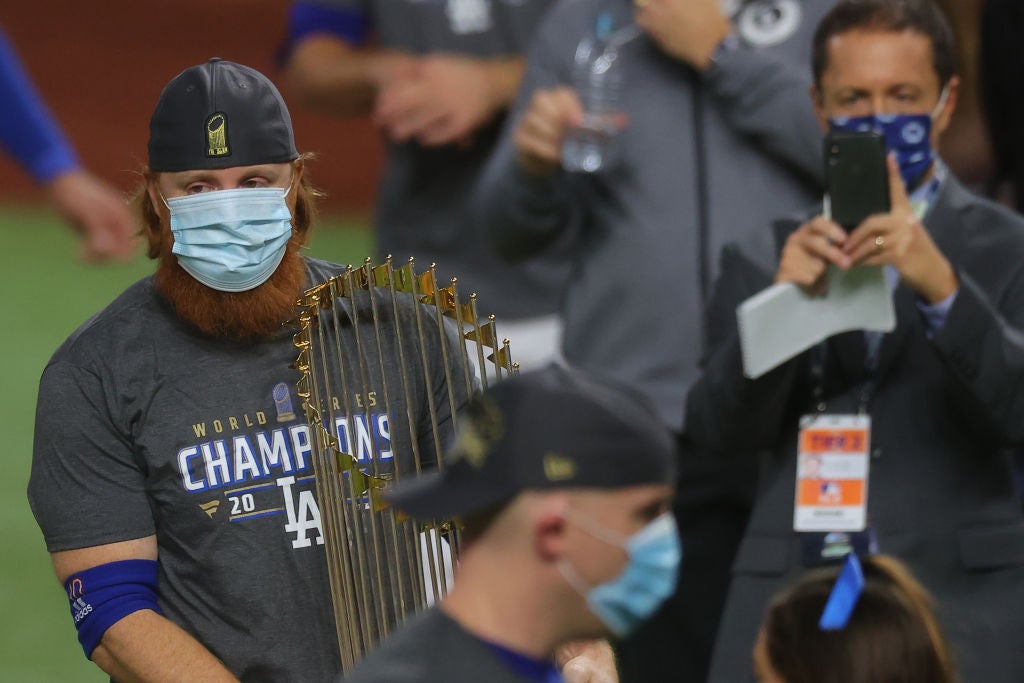 Justin Turner celebrates with the Commissioners Trophy after winning the World Series