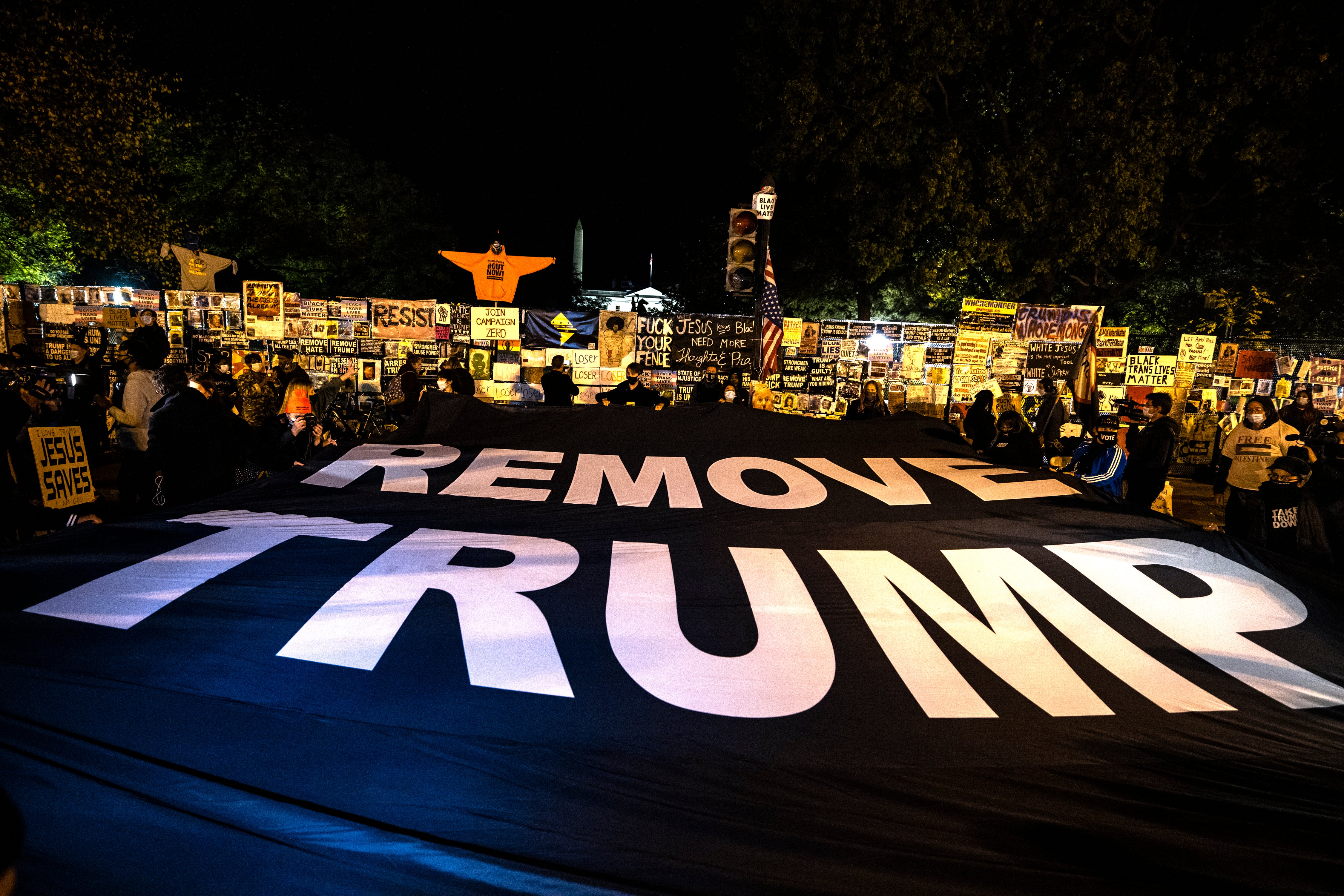 Los manifestantes despliegan una pancarta que dice "Elimine a Trump" en Black Lives Matter Plaza frente a la Casa Blanca el día de las elecciones.