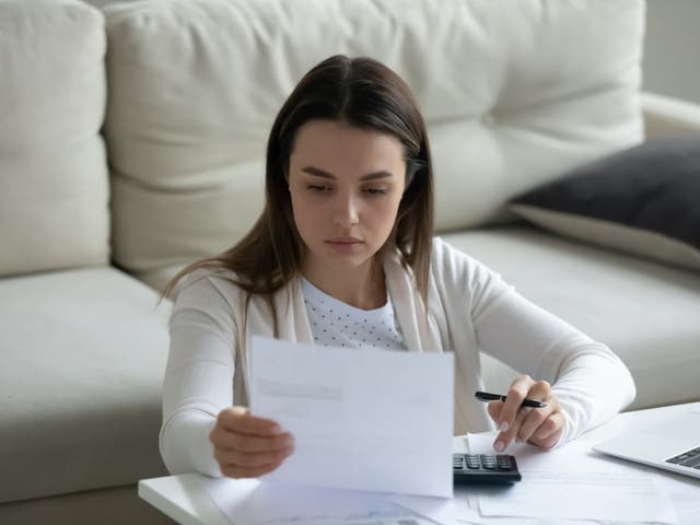 <p>A person at home calculating their bills</p>