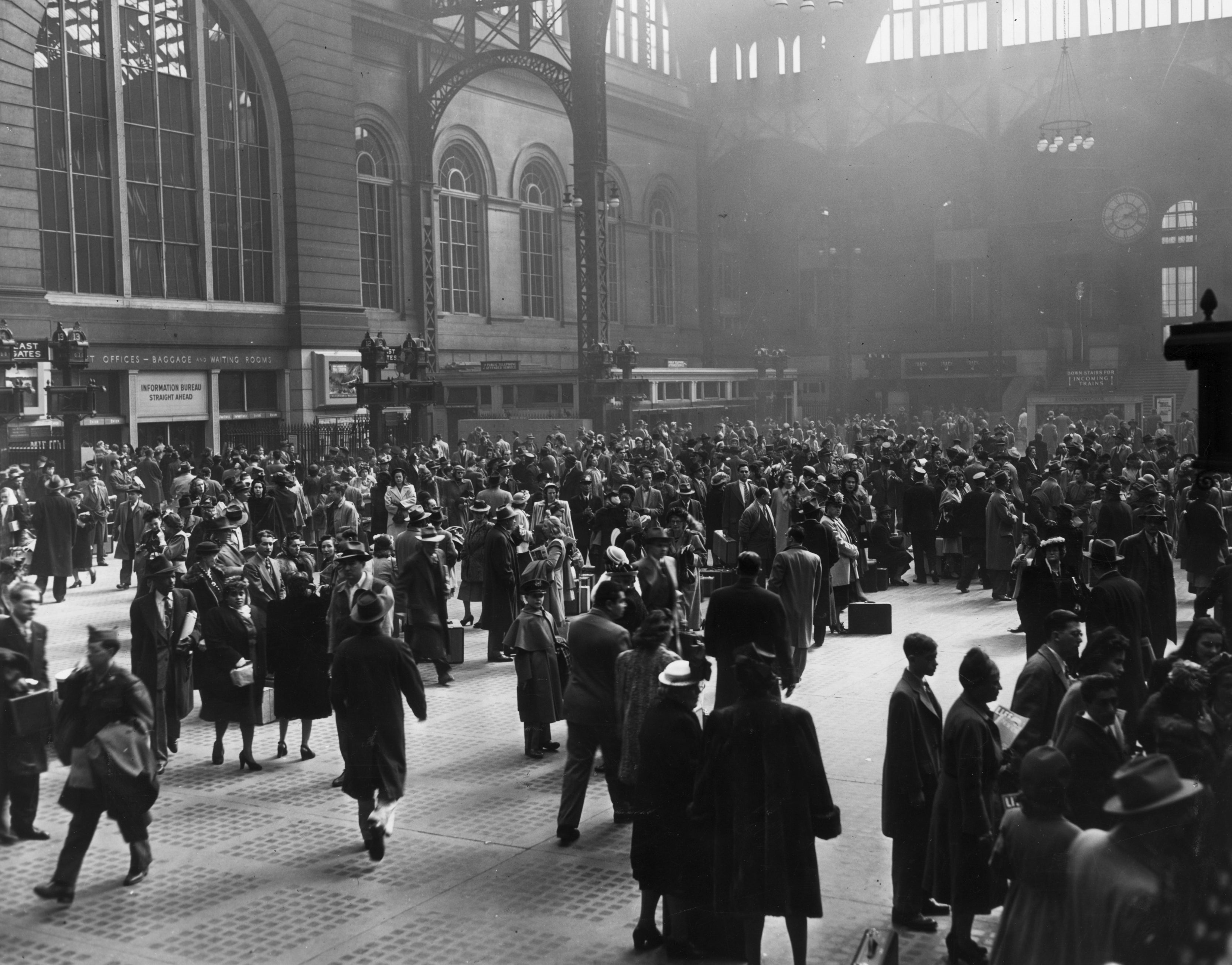 View of a crowd of people in the interior of the old Pennsylvania Rail Road Station, New York City, circa 1950