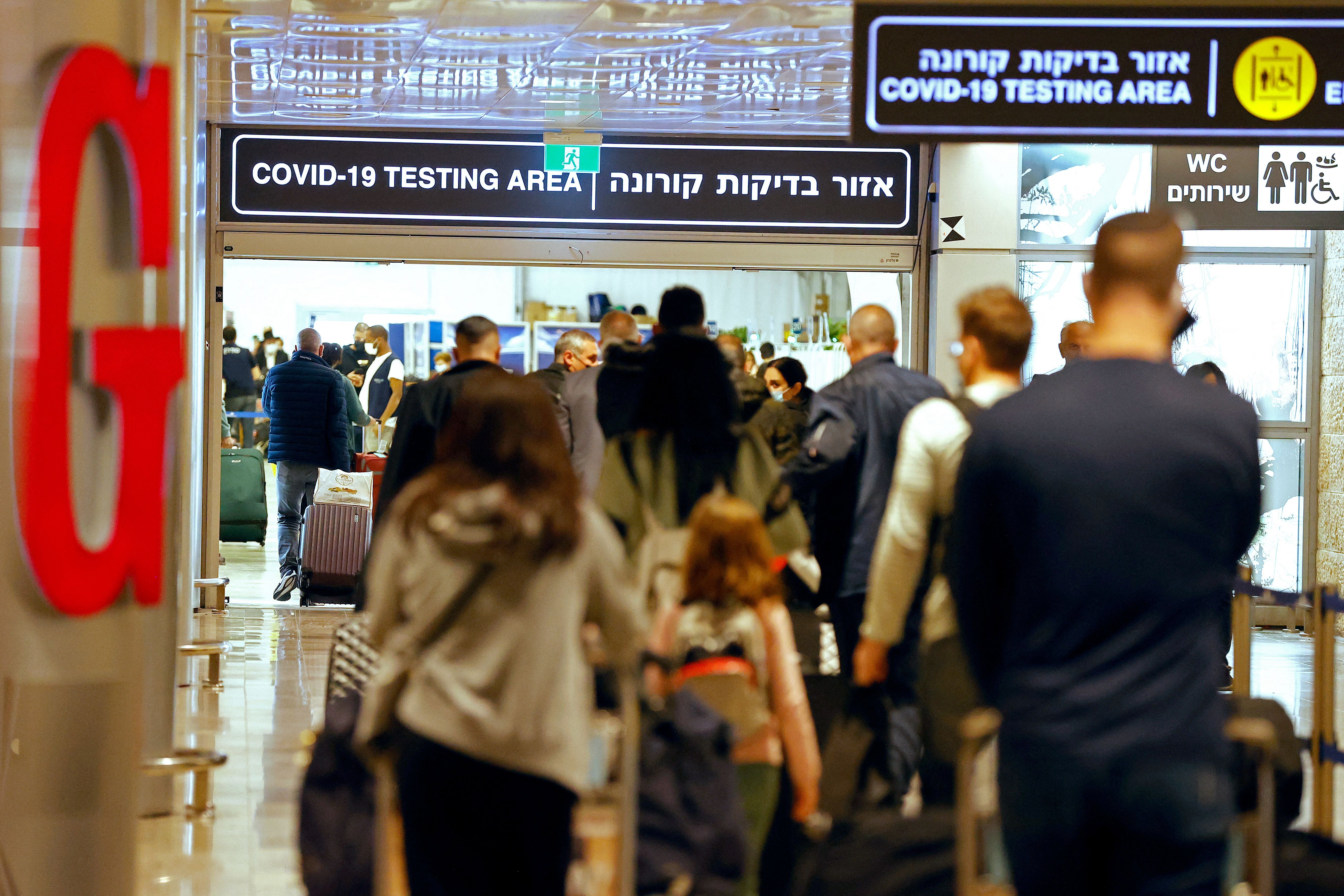 Pasajeros caminan con su equipaje a su llegada al aeropuerto israelí Ben Gurion