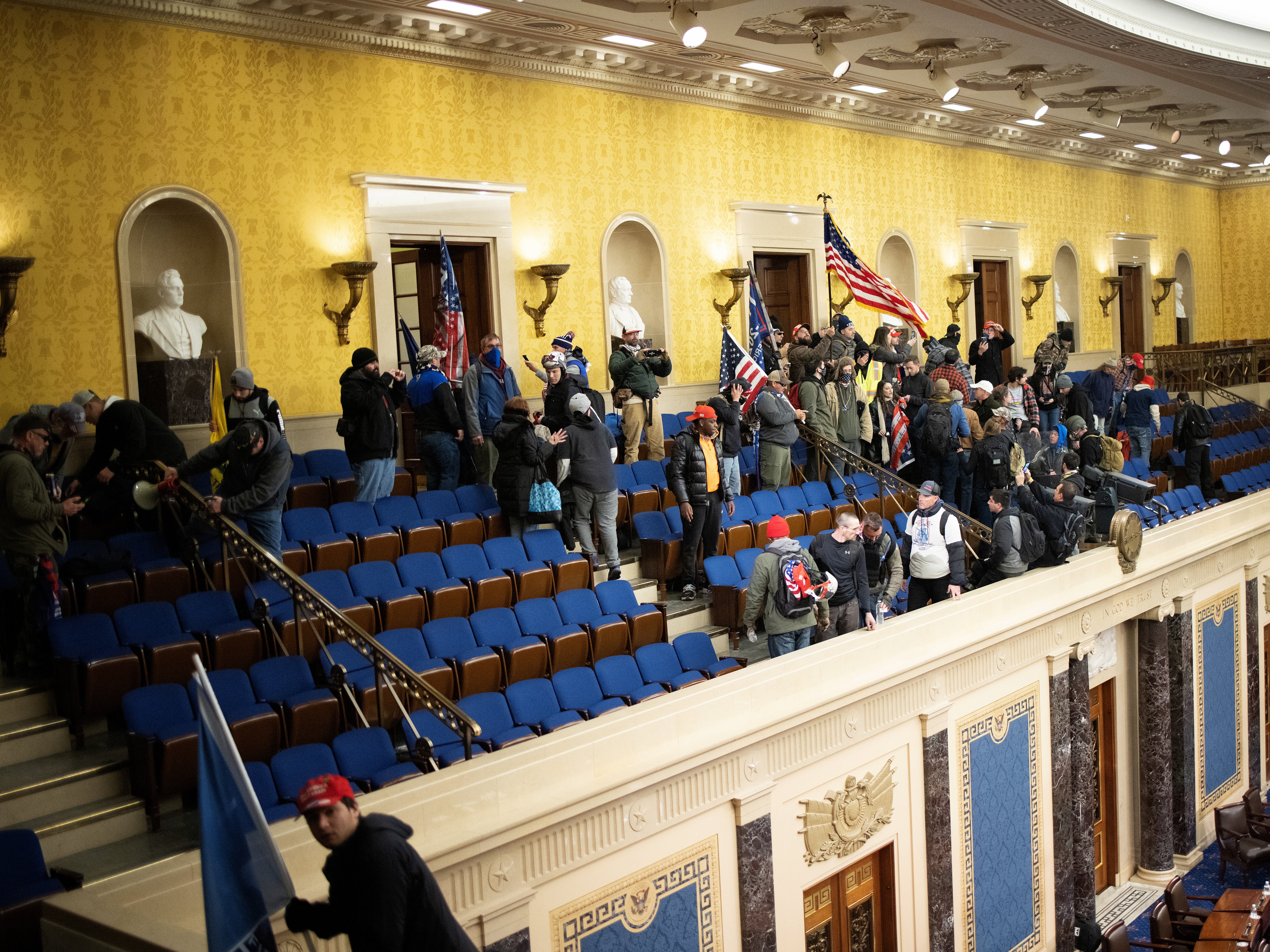 Una multitud pro-Trump se congrega adentro de la cámara del Senado en el Capitolio de los EE.UU. después de que ambos grupos asaltaran el edificio el 6 de enero del 2021