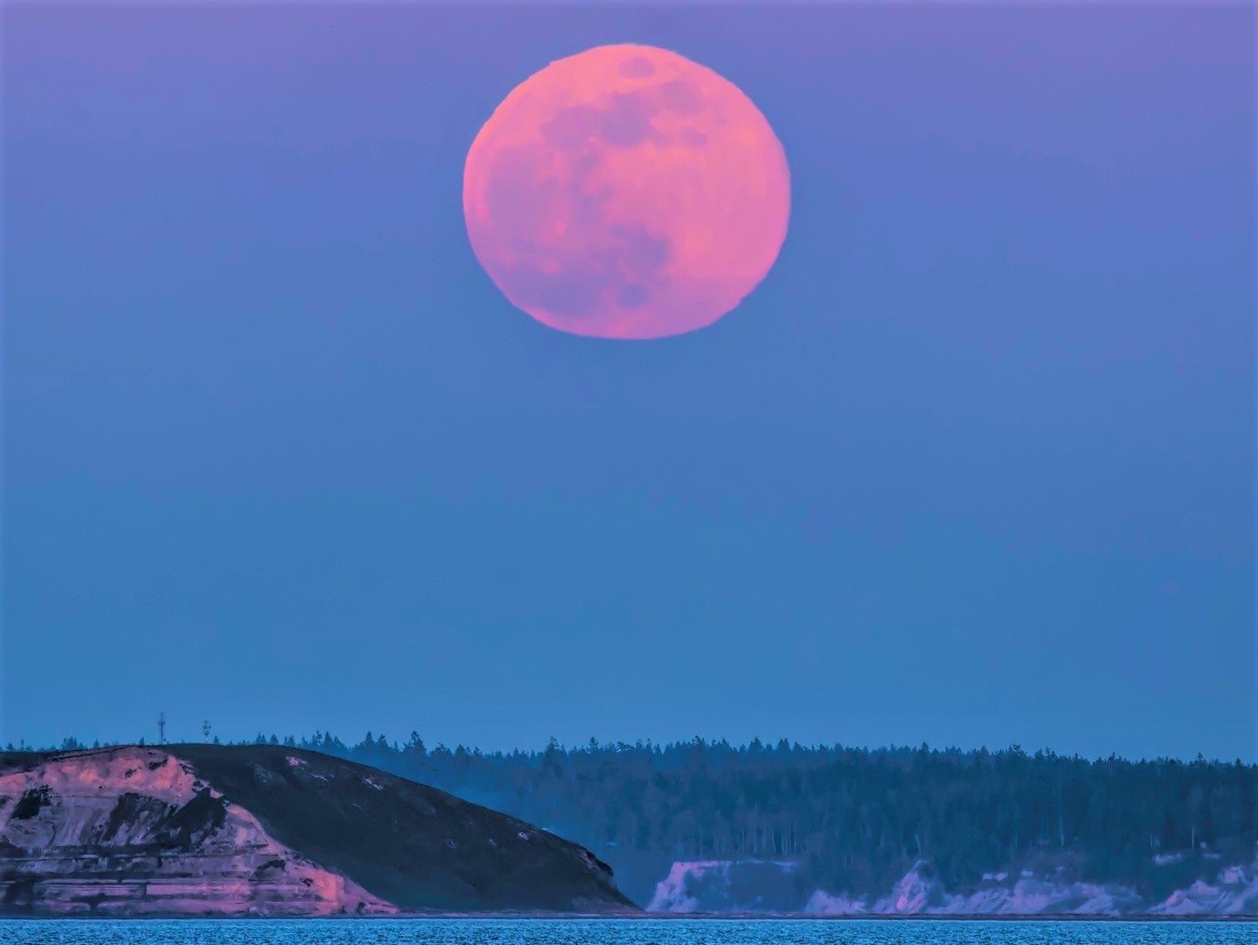 La superluna rosa sobre Protection Island Puget Sound, Estrecho de Juan de Fuca; la luna llena de este mes cae el 16 de abril de 2022