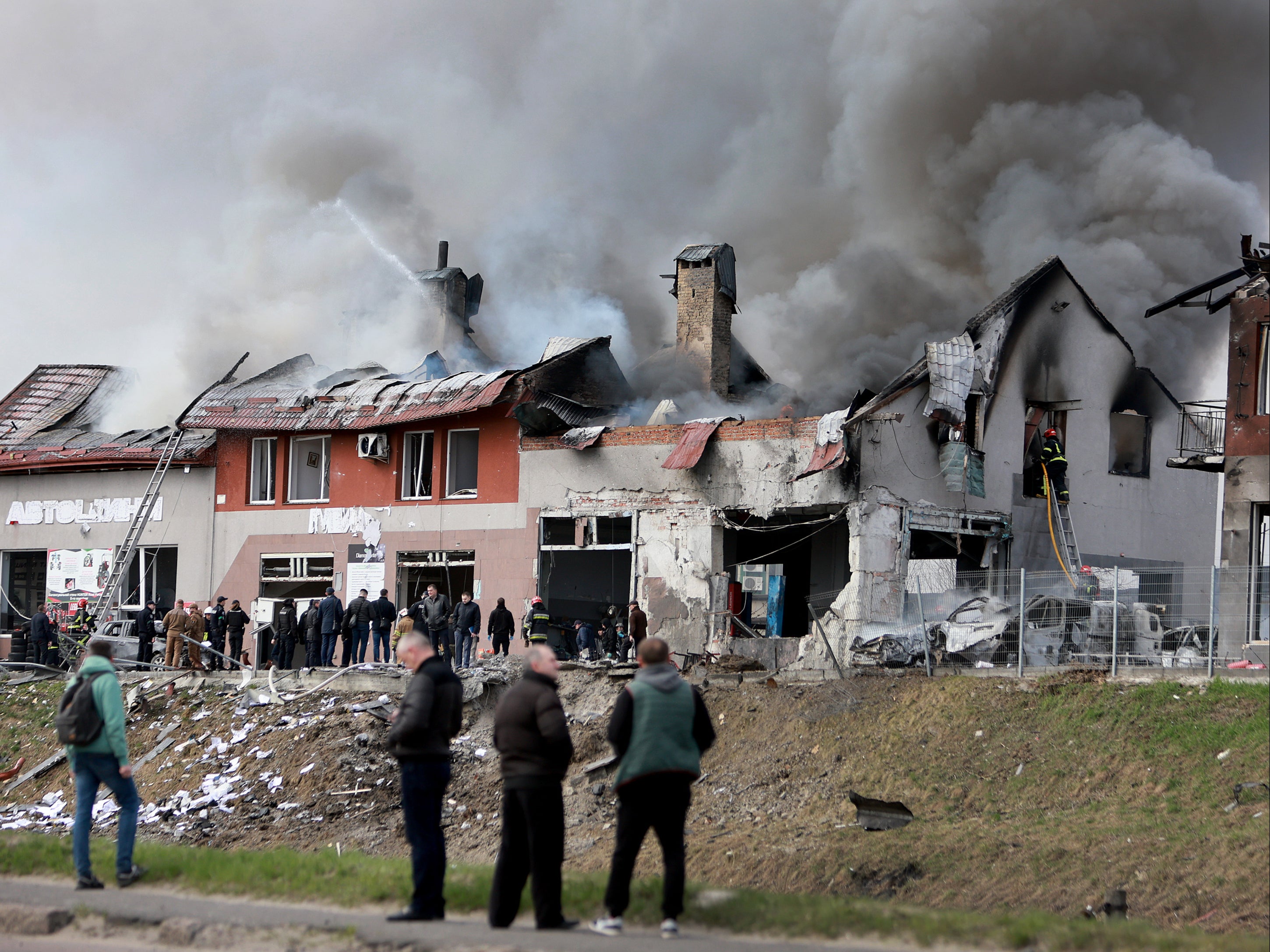 Los bomberos luchan contra un incendio después de que un edificio civil fuera alcanzado por un misil ruso en Lviv