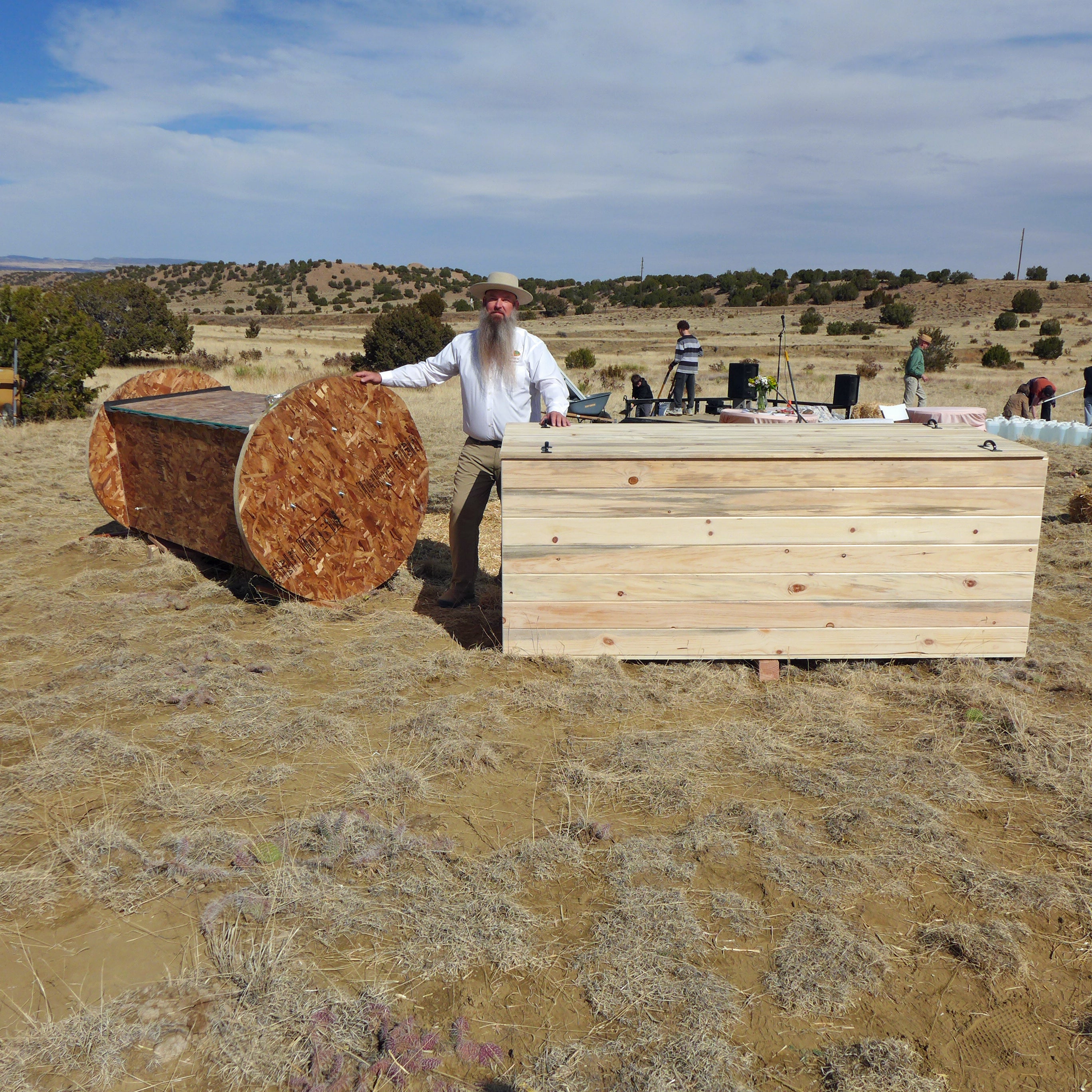 Seth Viddal, quien es copropietario de The Natural Funeral en Colorado, parado entre dos crisálidas hechas de forma especial que compostan los retos humanos