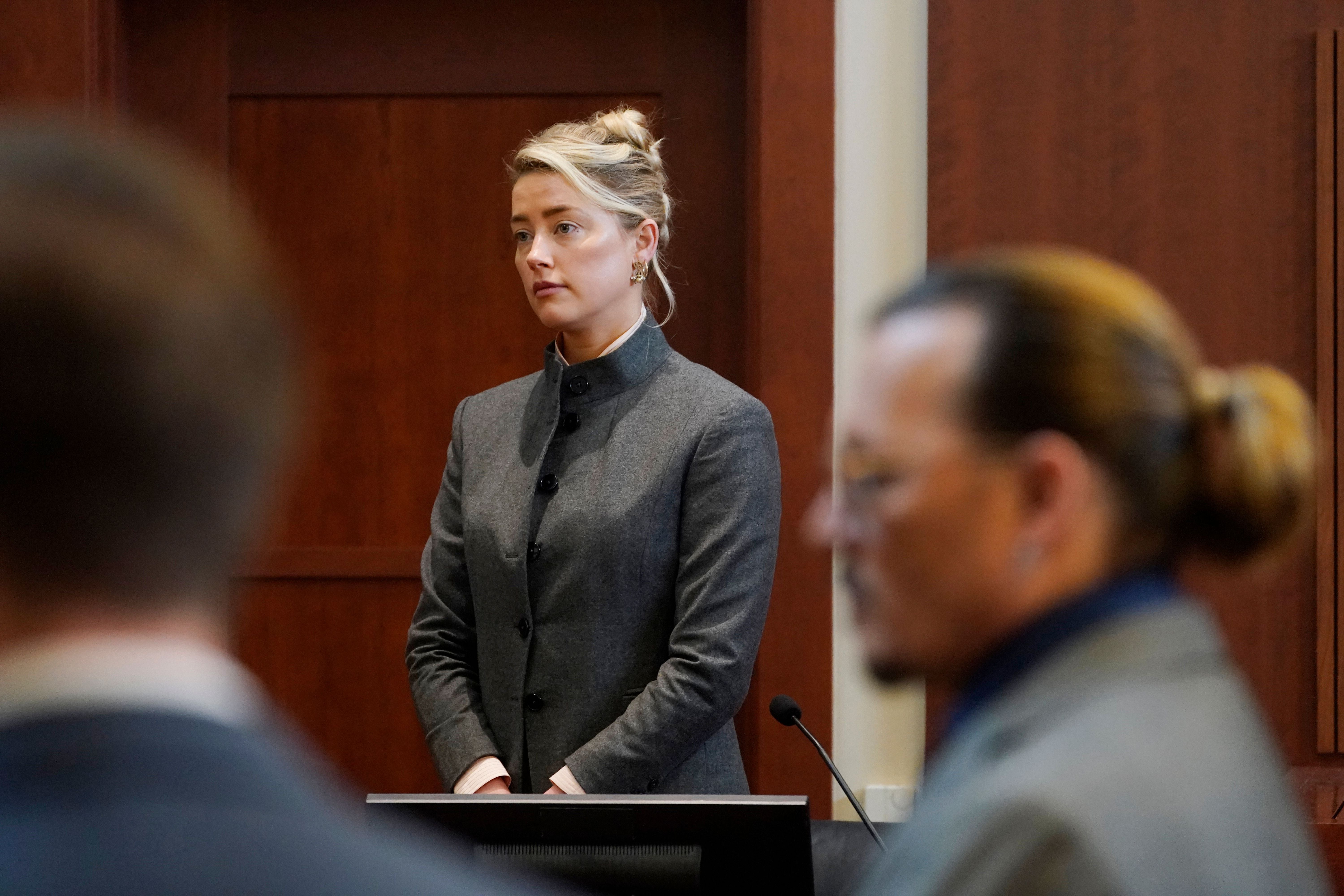 Amber Heard y Johnny Depp observan al jurado entrar a la sala de la corte en la Corte de Circuito del condado de Fairfax en Fairfax, Virginia, el 16 de mayo de 2022