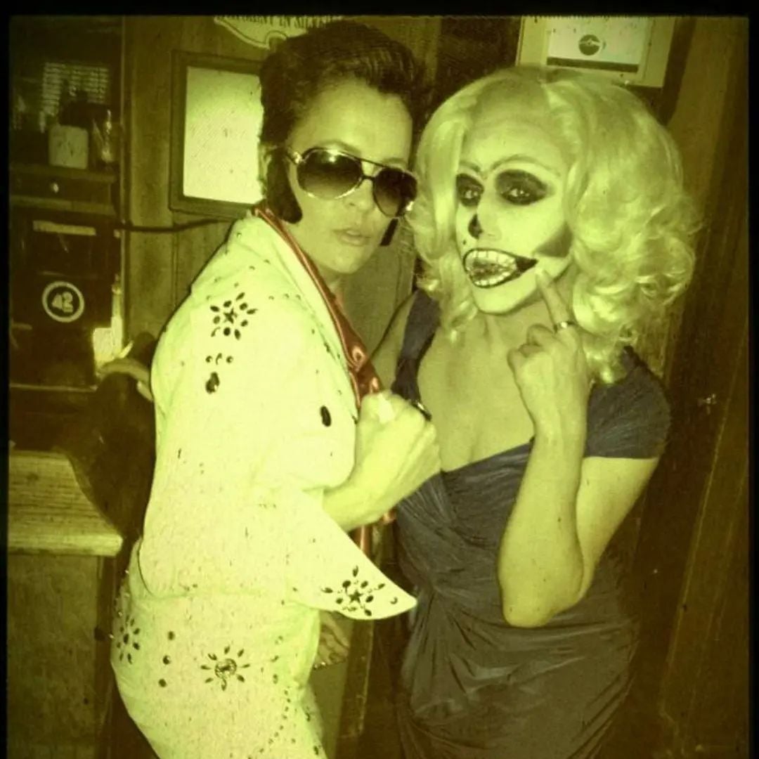 Kari Lake, left, dressed as Elvis, poses alongside drag queen Barbra Seville