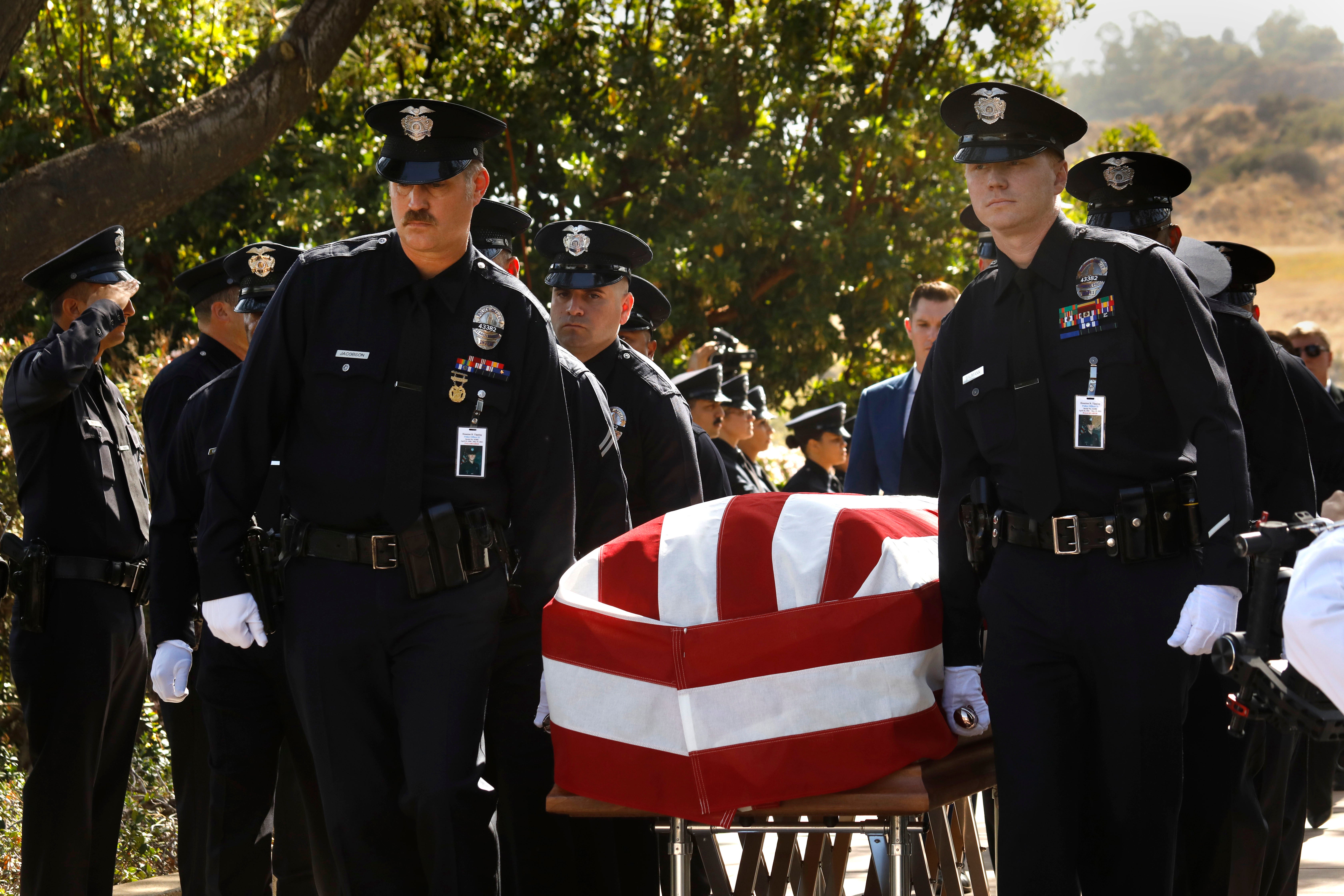 Oficiales del LAPD cargan el ataúd de Houston Tipping en su funeral el miércoles 22 de junio de 2022