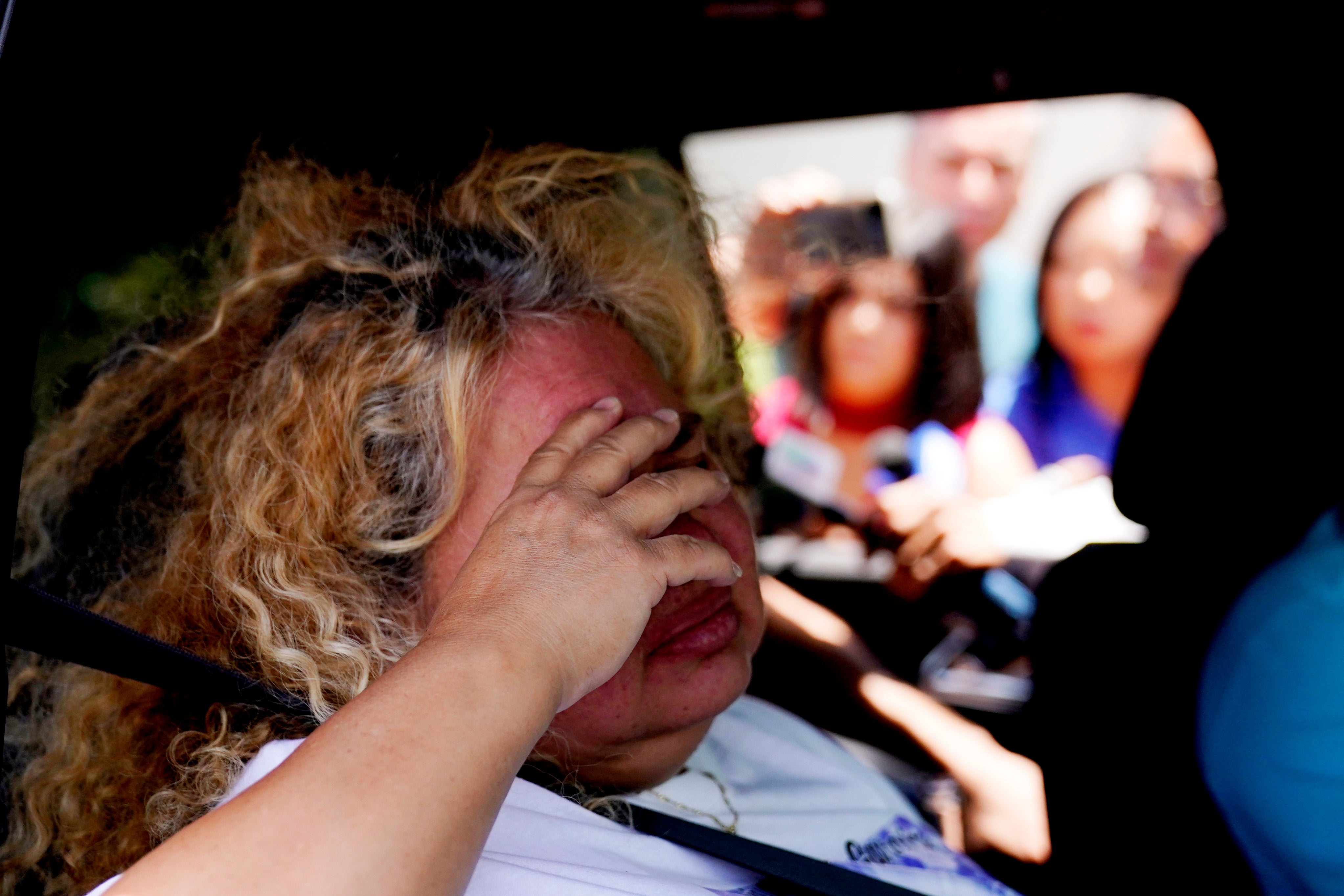 Grace Valencia, great aunt of shooting victim Uziyah Garcia, sobs after picking up a copy of the report
