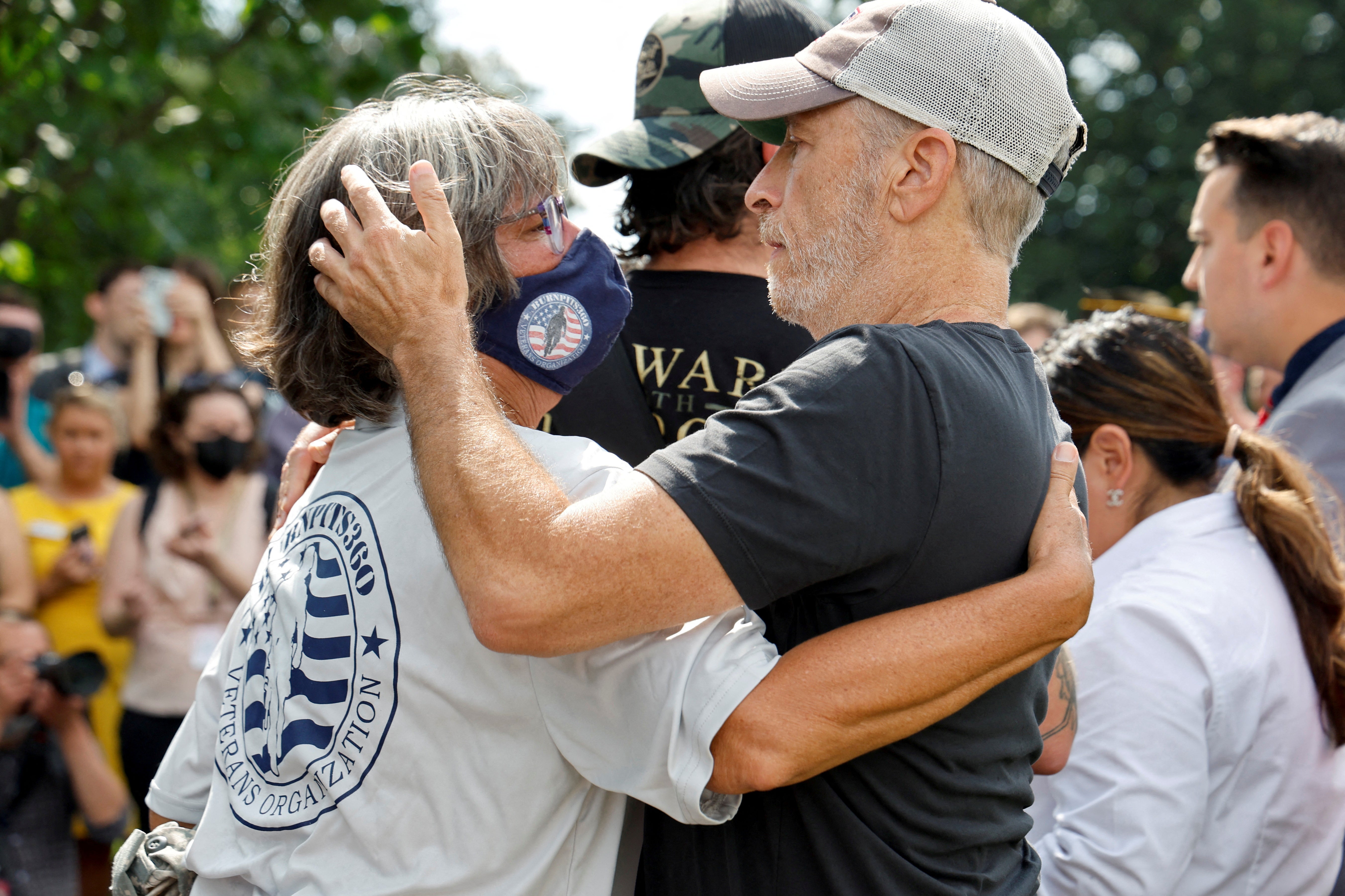El cómico Jon Stewart abraza a Susan Zeier en la rueda de prensa del 28 de julio