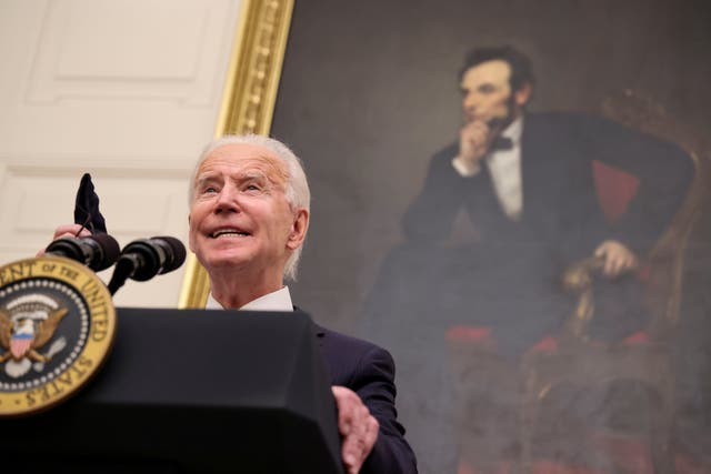 <p>With a portrait of former President Abraham Lincoln hanging in the background, President Joe Biden speaks about Covid-19</p>