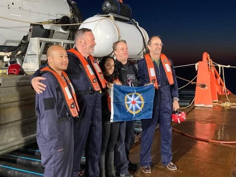 Renata Rojas, centre, poses with members of her July 2022 dive down to the wreckage of Titanic