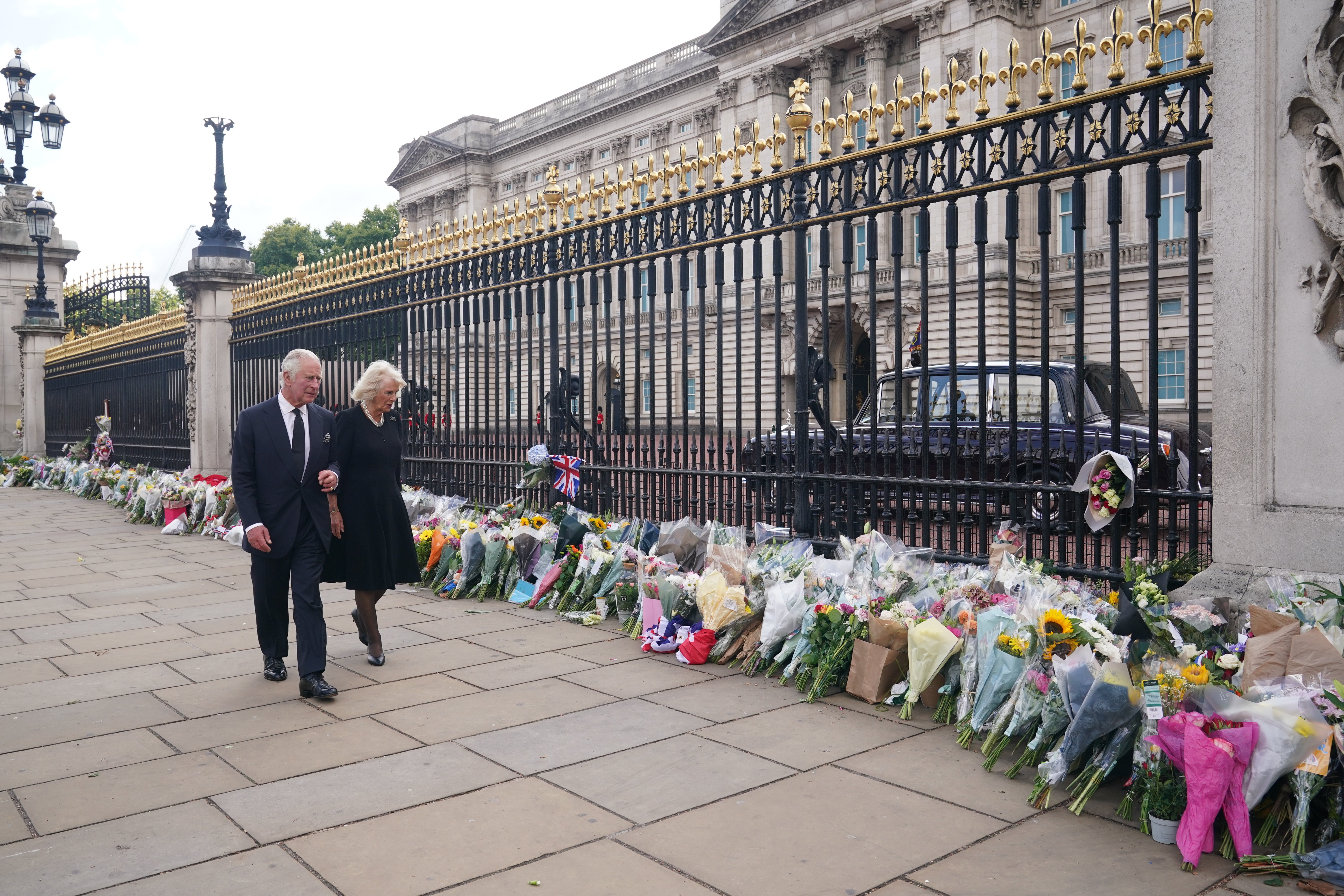 King Charles III and the Queen view tributes left outside Buckingham Palace (Yui Mok/PA)