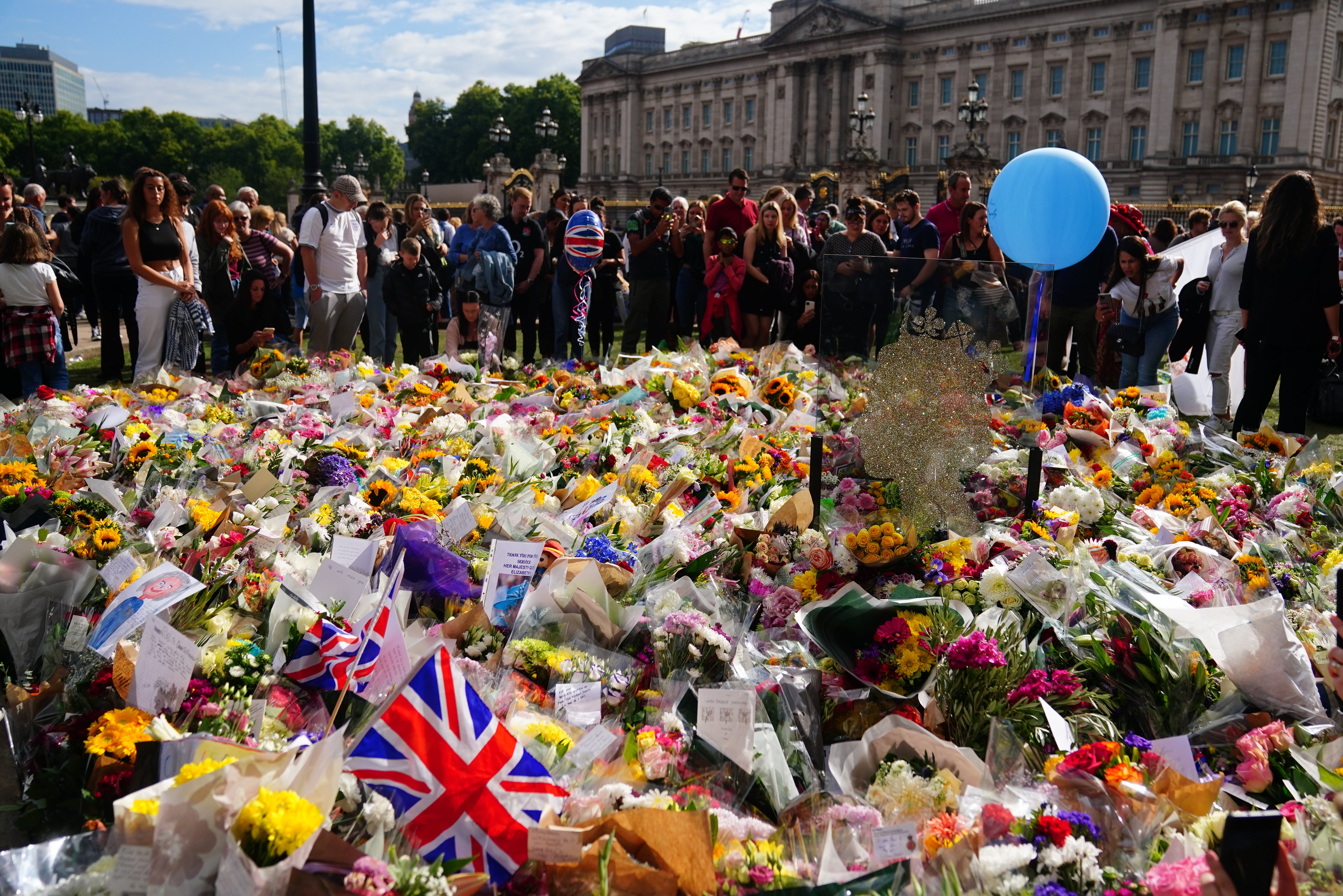 Flowers and tributes outside Buckingham Palace (Victoria Jones/PA)