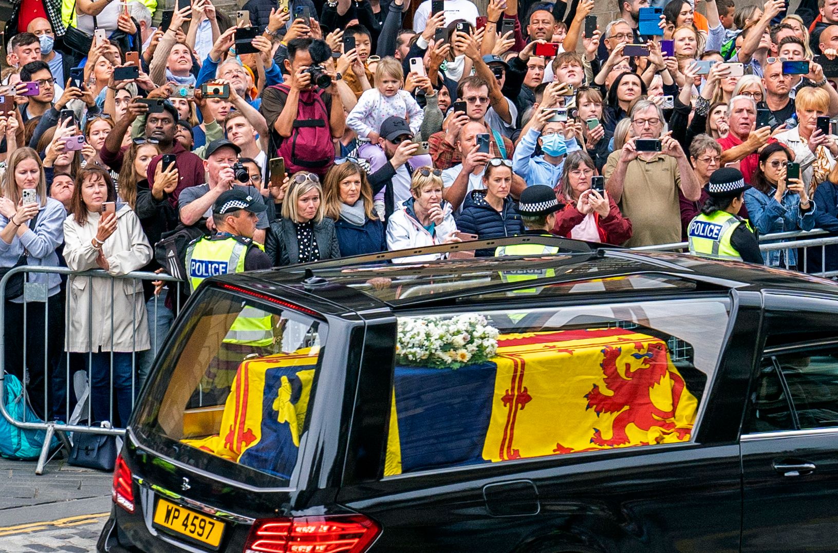 Crowds line the Royal Mile as the procession travels through Edinburgh