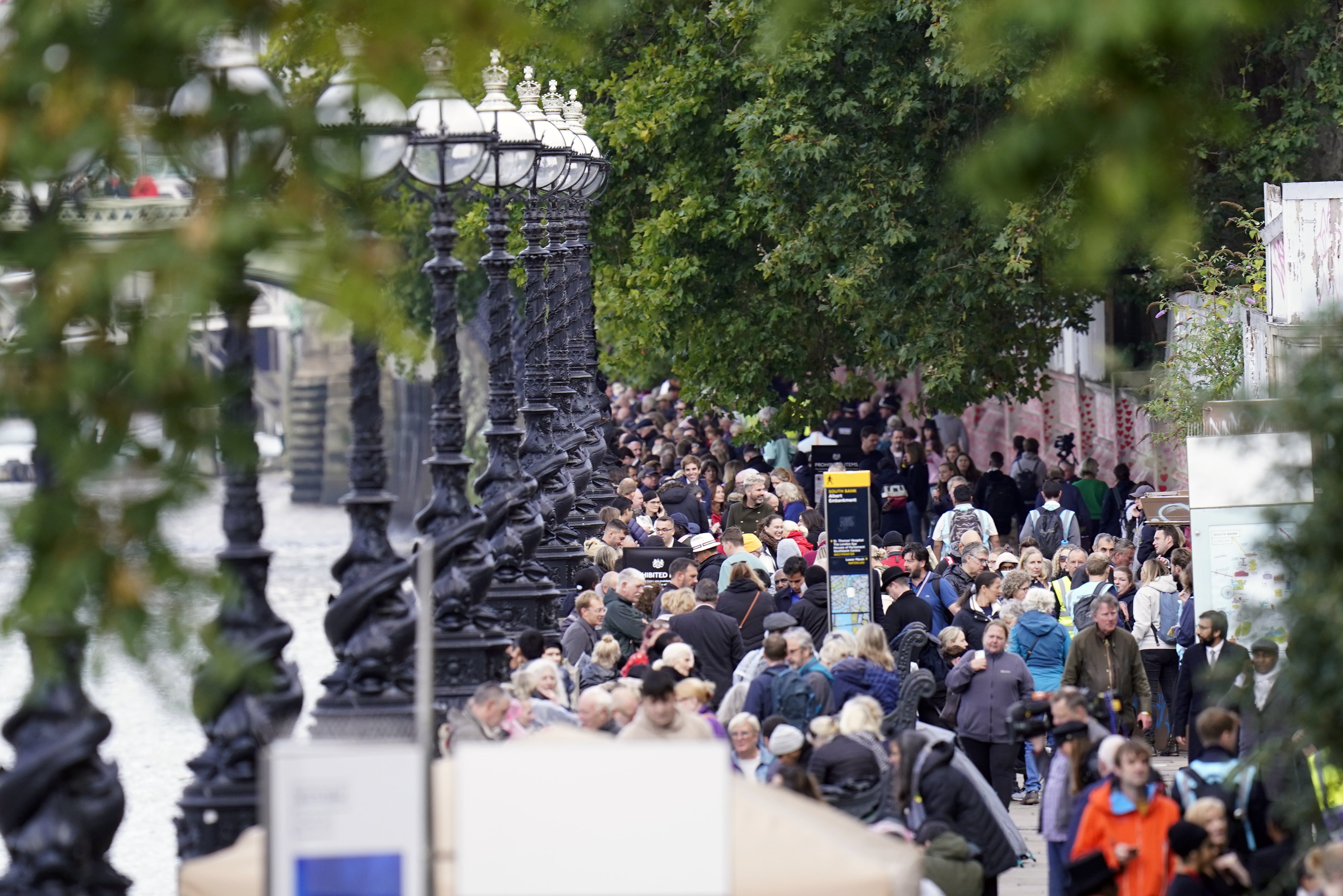 Members of the public wait in the queue near Lambeth Bridge in central London, to view Queen Elizabeth II lying in state (Danny Lawson/PA)