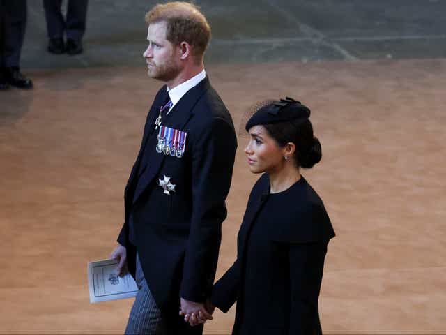 <p>File Prince Harry and Meghan, Duchess of Sussex walk as procession with the coffin of Britain's Queen Elizabeth arrives at Westminster Hall </p>