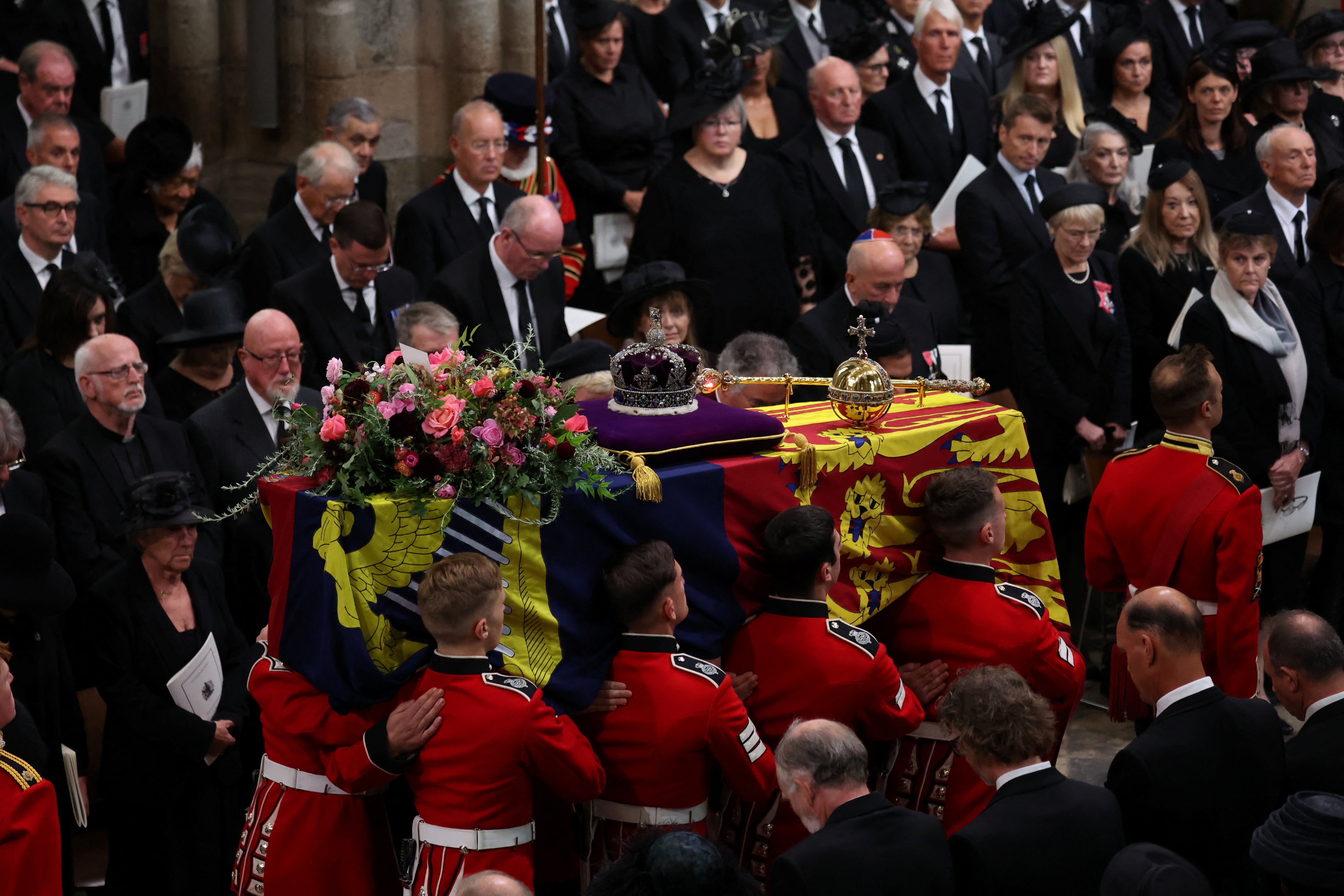 The Queen’s coffin is carried through Westminster Abbey.