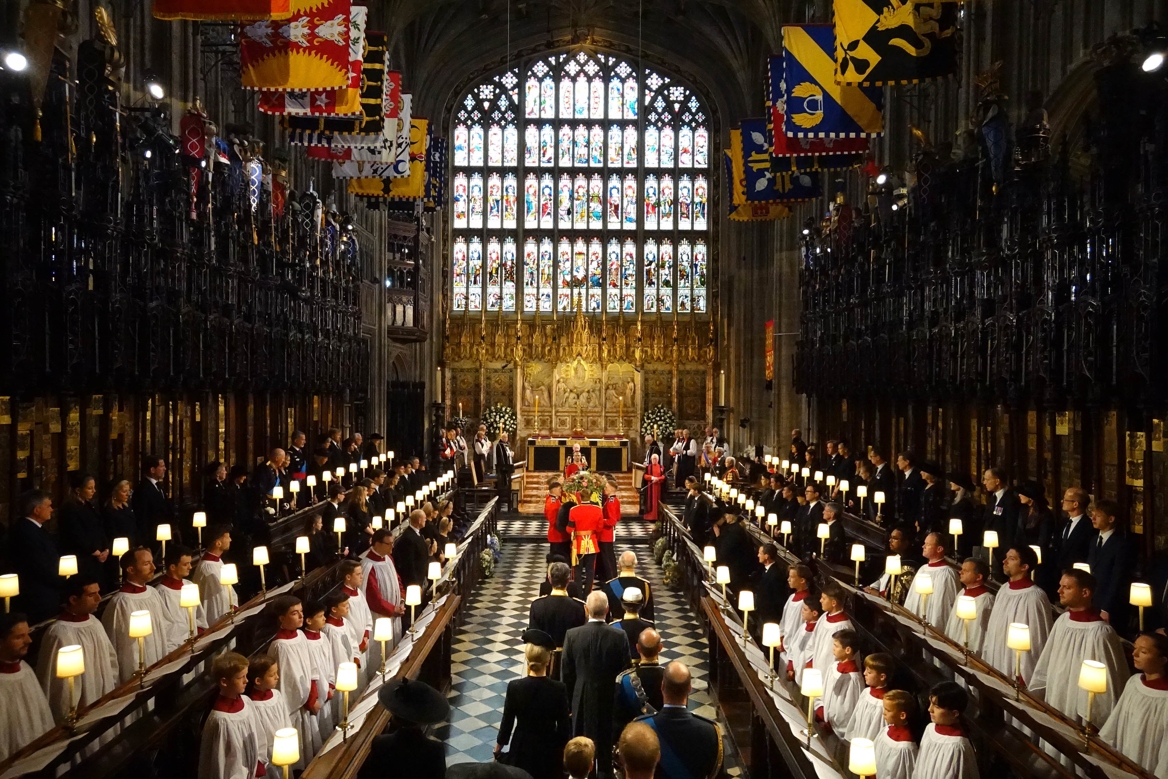 King Charles III and members of the royal family follow behind the coffin of Queen Elizabeth II as it is carried into St George’s Chapel in Windsor Castle.