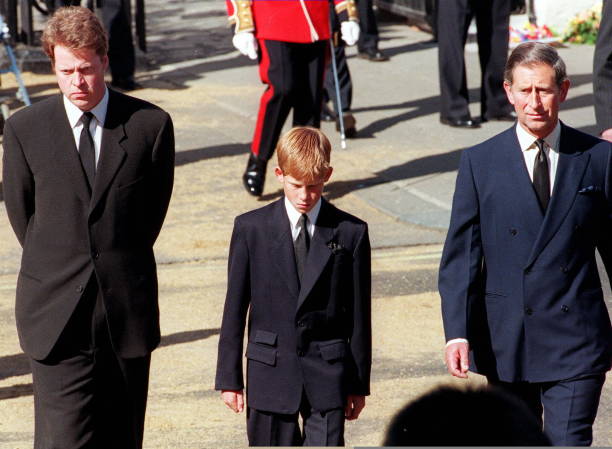 Earl Spencer, Diana’s brother, Prince Harry, her son, and Prince Charles, her former husband, join the gun carriage carrying the coffin of Princess of Wales at Marlboro Road in London during the funeral