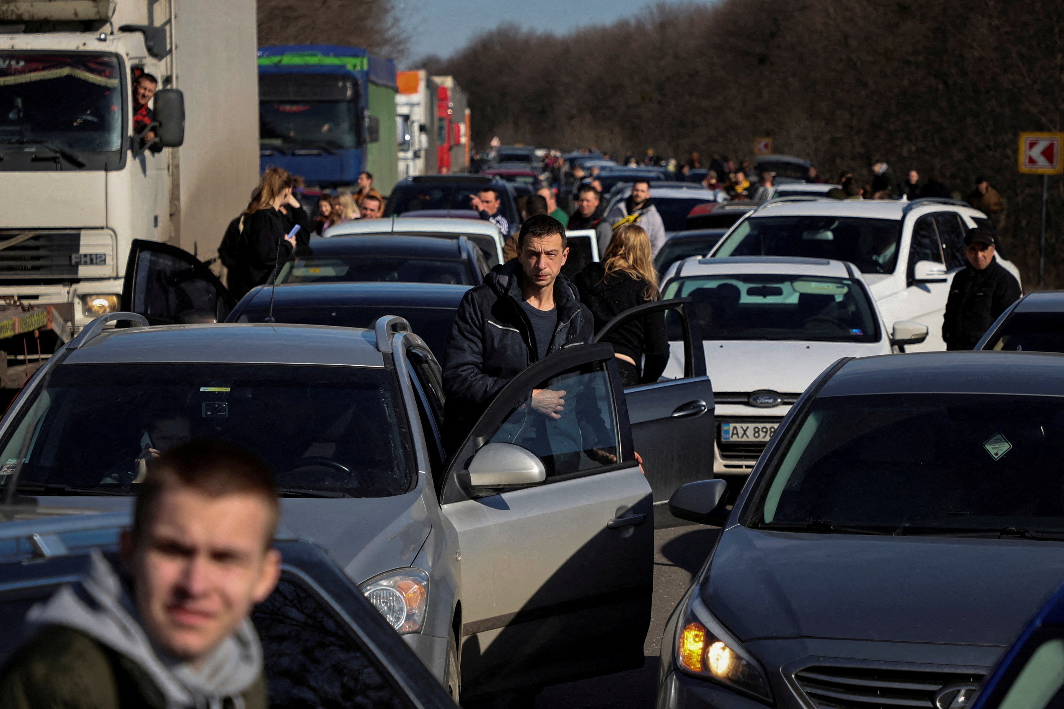People wait in a traffic jam as they flee Kharkiv after Russian President Vladimir Putin authorised a military operation in eastern Ukraine, in Kharkiv region, Ukraine, February 24, 2022
