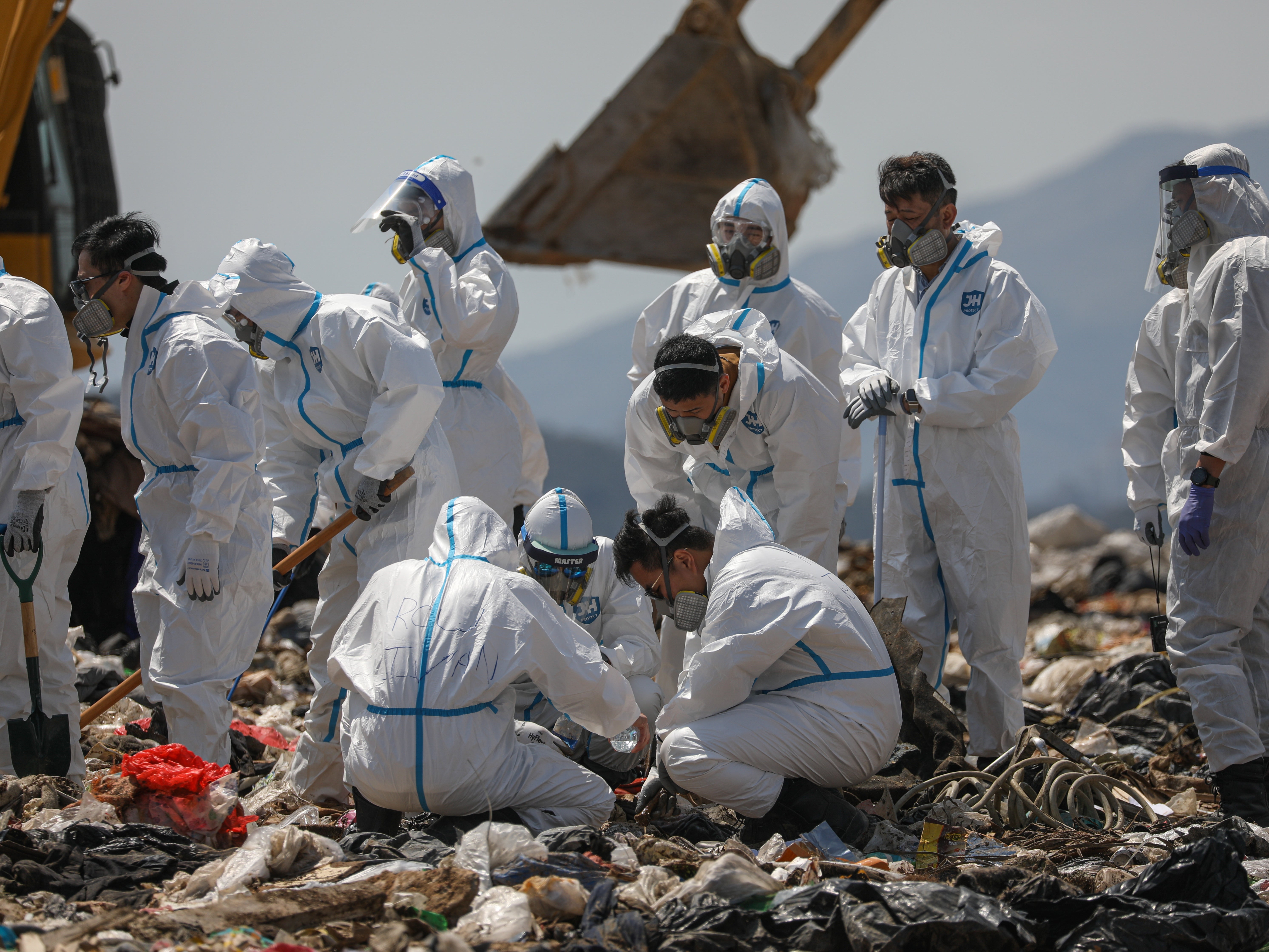 Hong Kong police officers comb through garbage for the remains of murdered model Abby Choi on 28 February 2023
