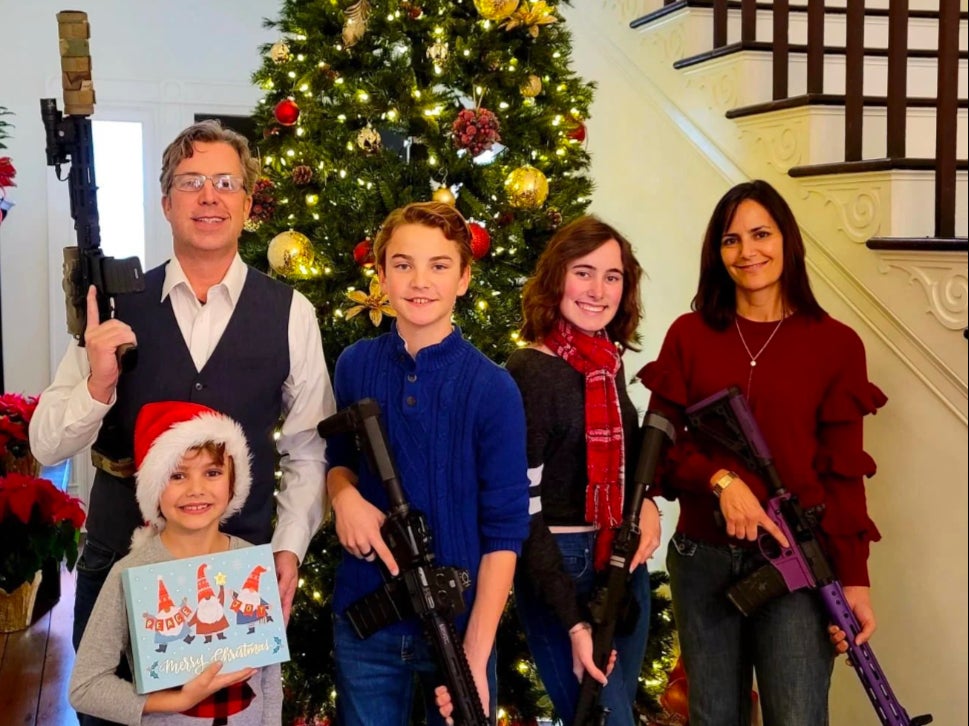 Andy Ogles and his family pose for a 2021 Christmas photo with firearms in an image published on his Facebook page