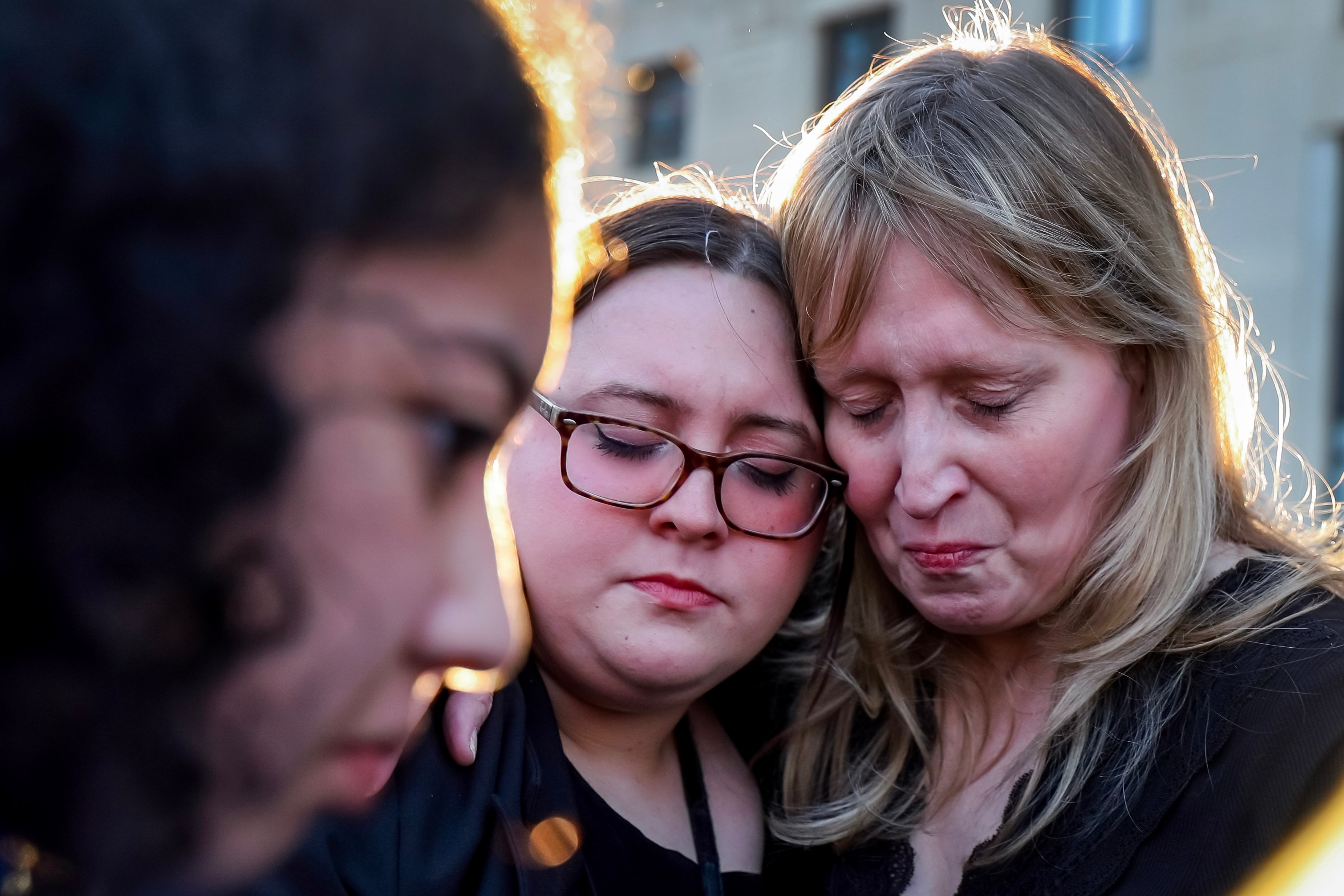 People react during a memorial vigil for the victims of the Covenant Presbyterian Church school shooting in Nashville