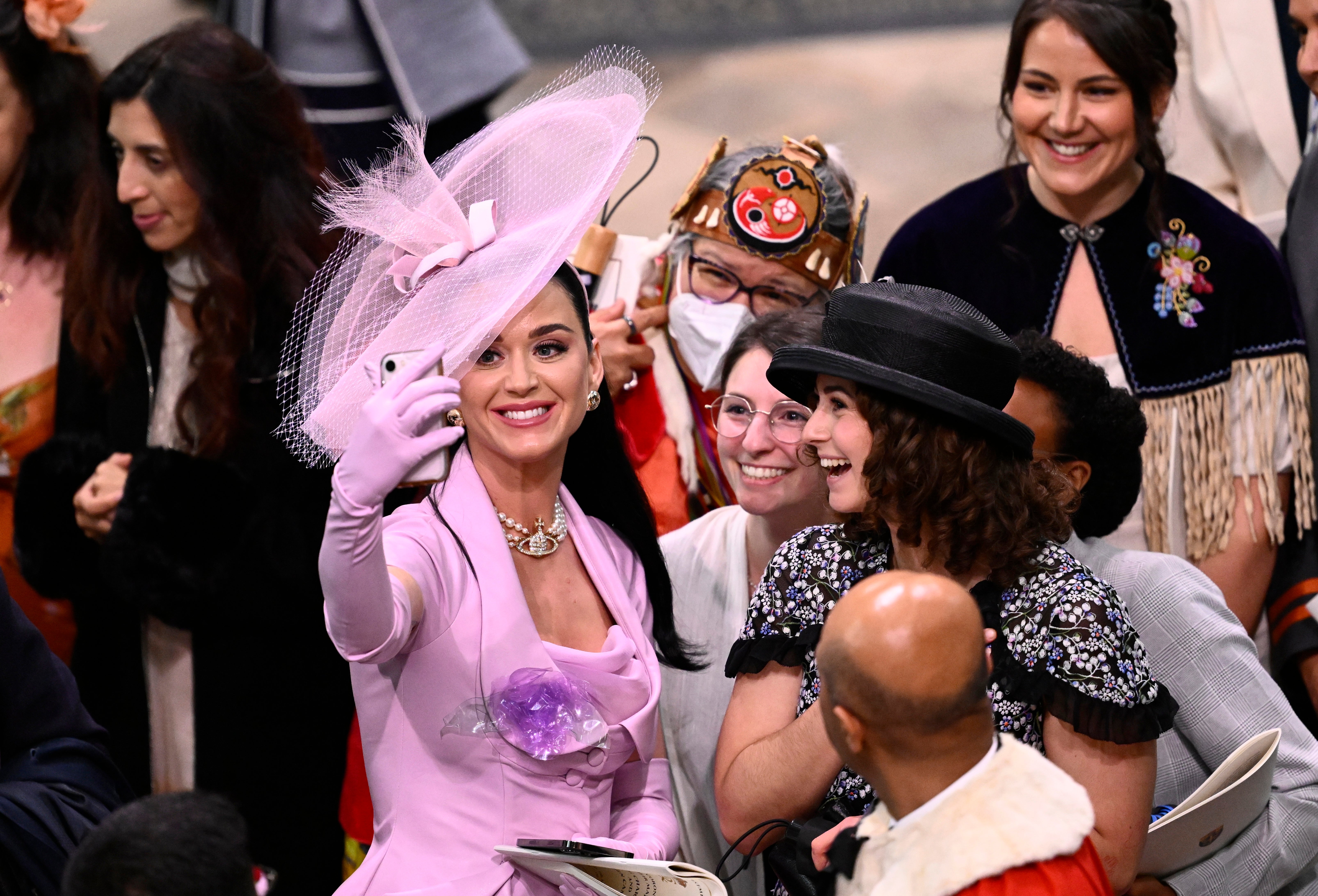<p>Katy Perry takes selfies with guests during the Coronation of King Charles III and Queen Camilla</p>