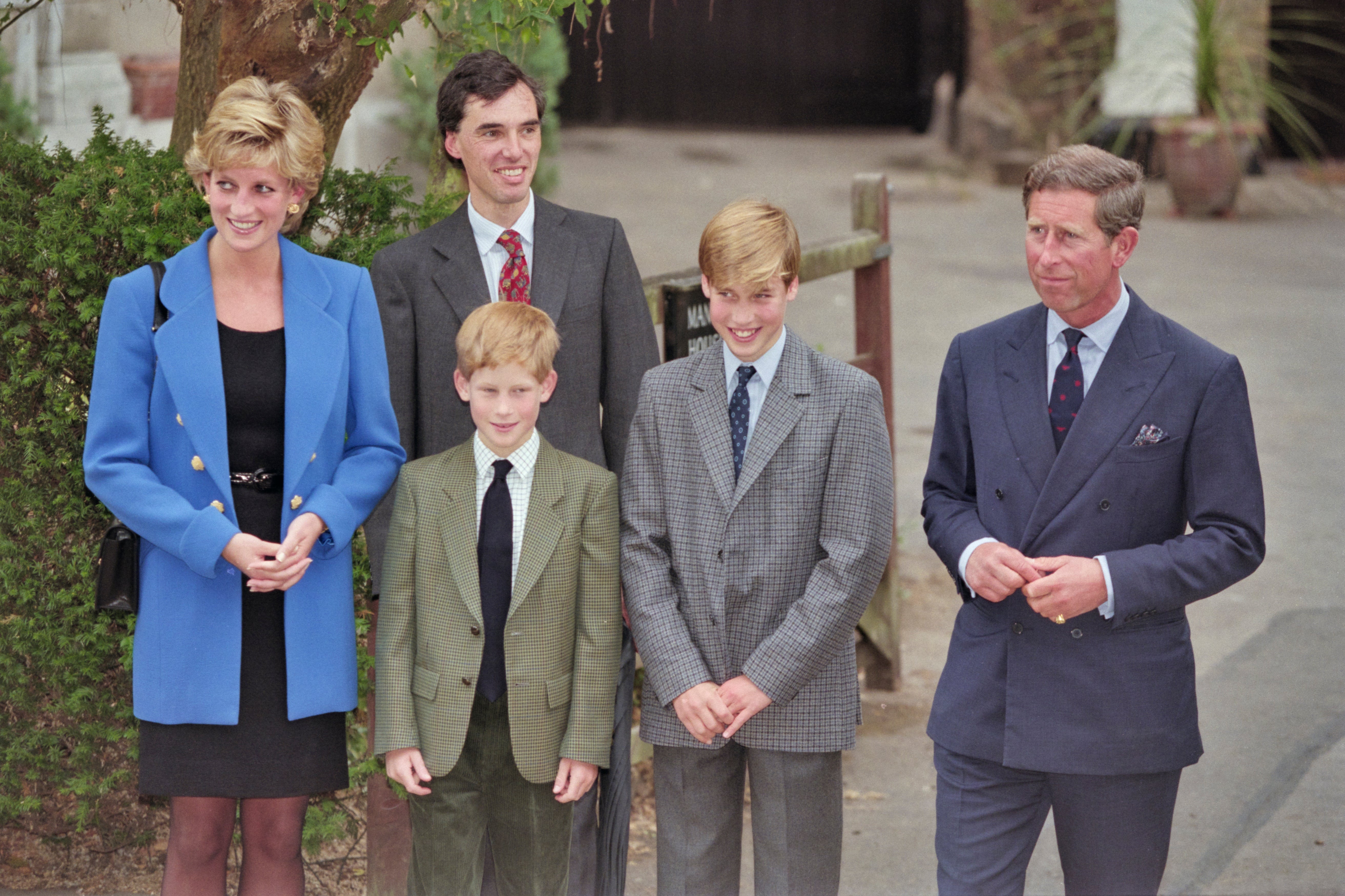 Diana, Princess of Wales (1961-1997), wearing a blue jacket over a black dress, with Eton housemaster Dr Andrew Gailey, Prince Harry, Prince William, and Prince Charles outside Manor House on Prince William's first day at Eton College in Eton