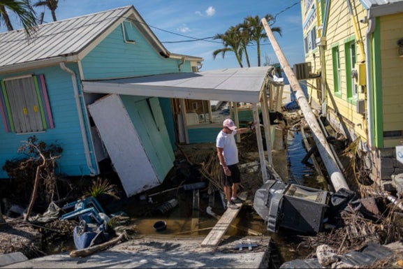 Victim of Hurricane Ian surveys damage left after the powerful hurricane hit Florida in September 2022