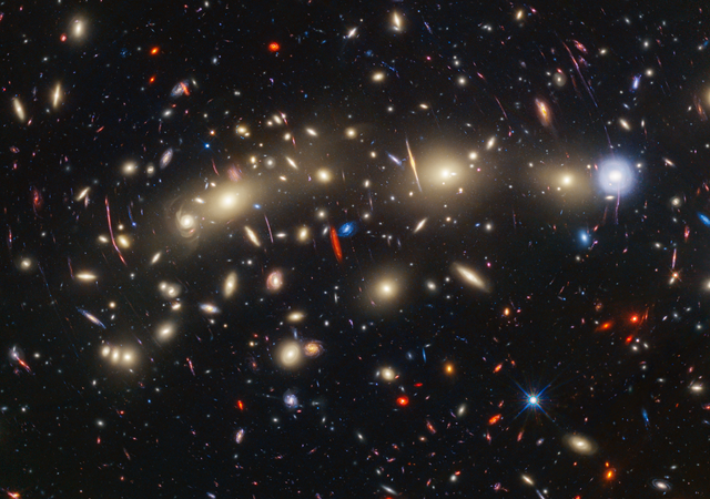 <p>This panchromatic view of galaxy cluster MACS0416 was created by combining infrared observations from NASA’s James Webb Space Telescope with visible-light data from NASA’s Hubble Space Telescope</p>