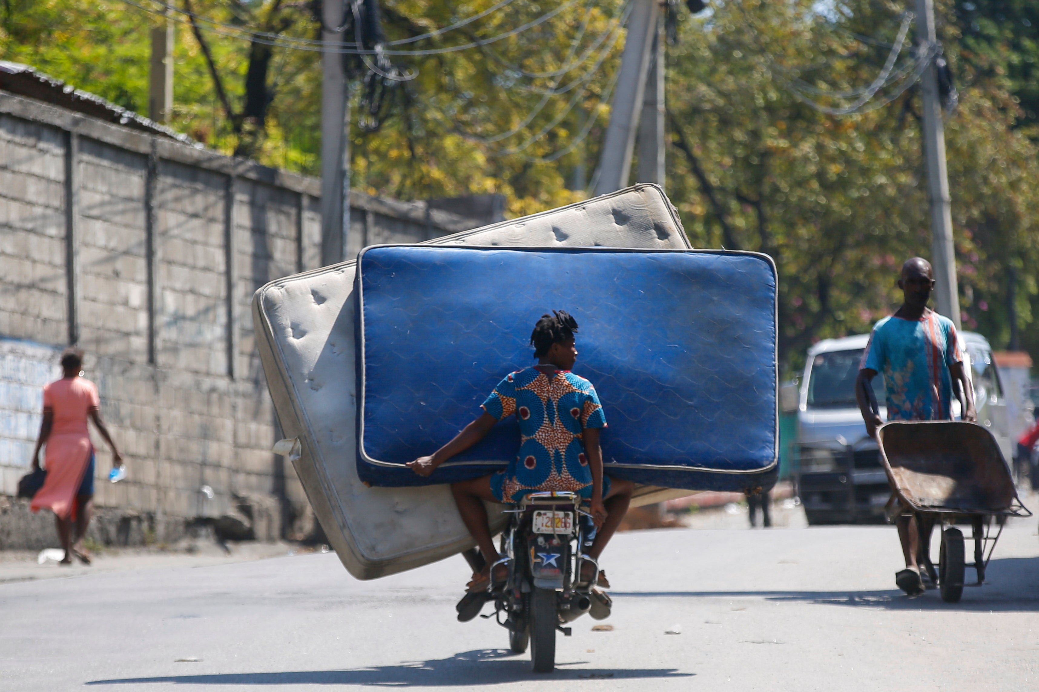 Residentes transportan colchones en una motocicleta en Puerto Príncipe, Haití, el lunes 4 de marzo
