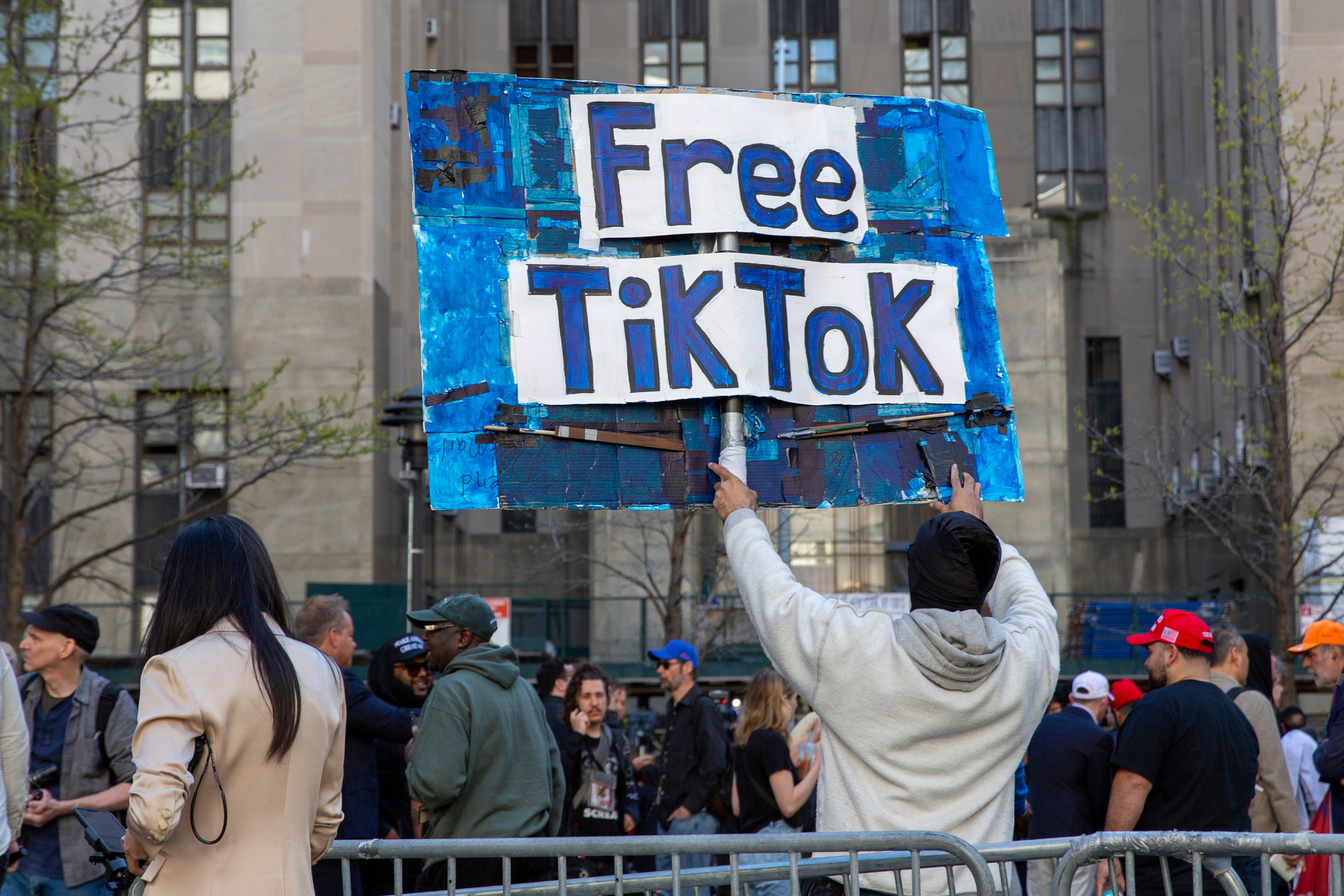 Un hombre sostiene un cartel de “TikTok libre” delante del tribunal en el que se celebra el juicio por soborno antes de que la Cámara de Representantes apruebe el proyecto de ley