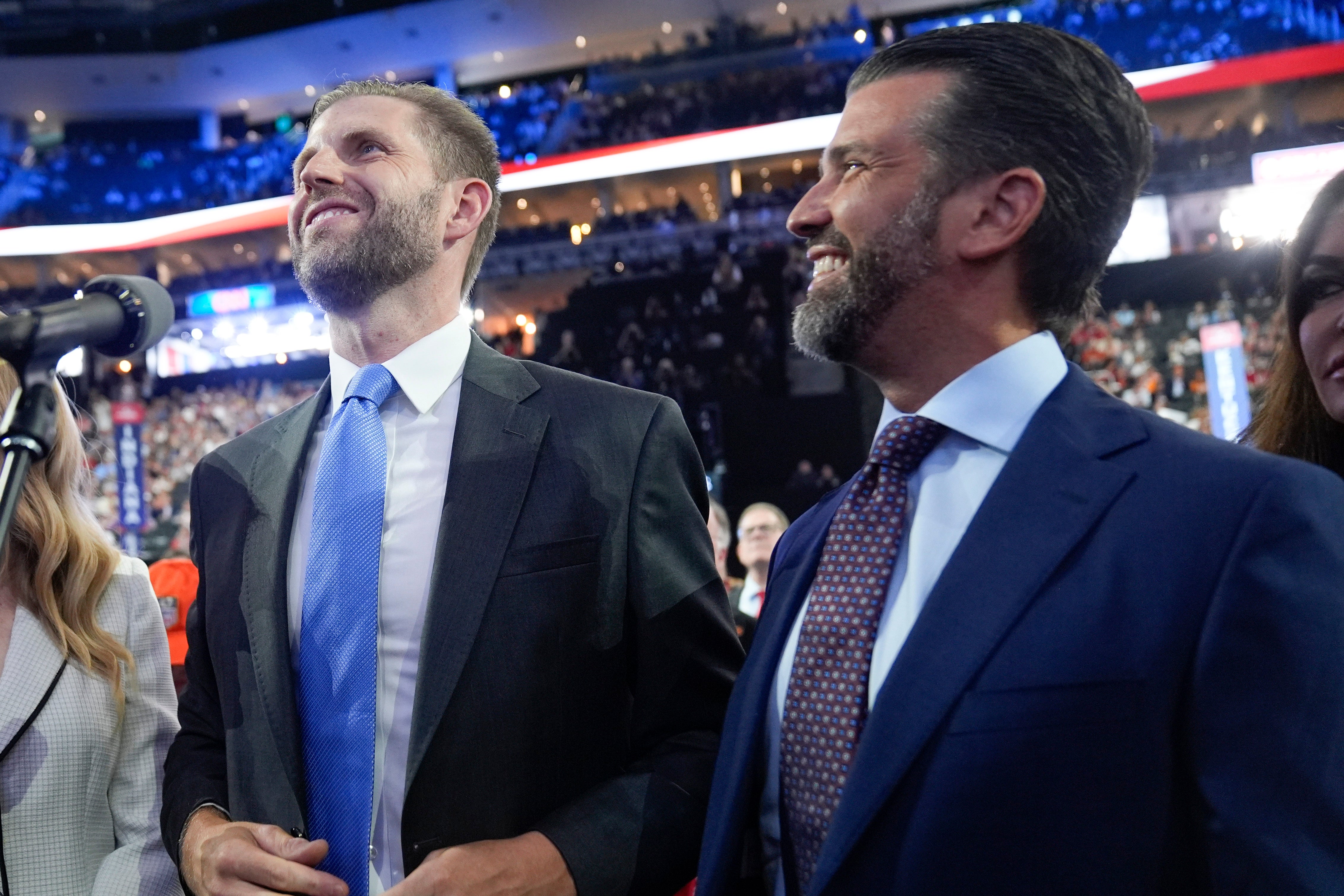 Eric Trump and Donald Trump Jr., smile as they watch the roll call of states during the first day of the Republican National Convention, Monday, July 15, 2024, in Milwaukee. (AP Photo/Evan Vucci)