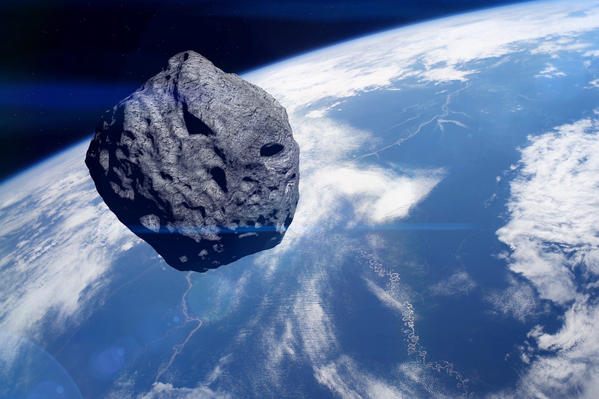 Representación artística de un asteroide orbitando cerca de la Tierra