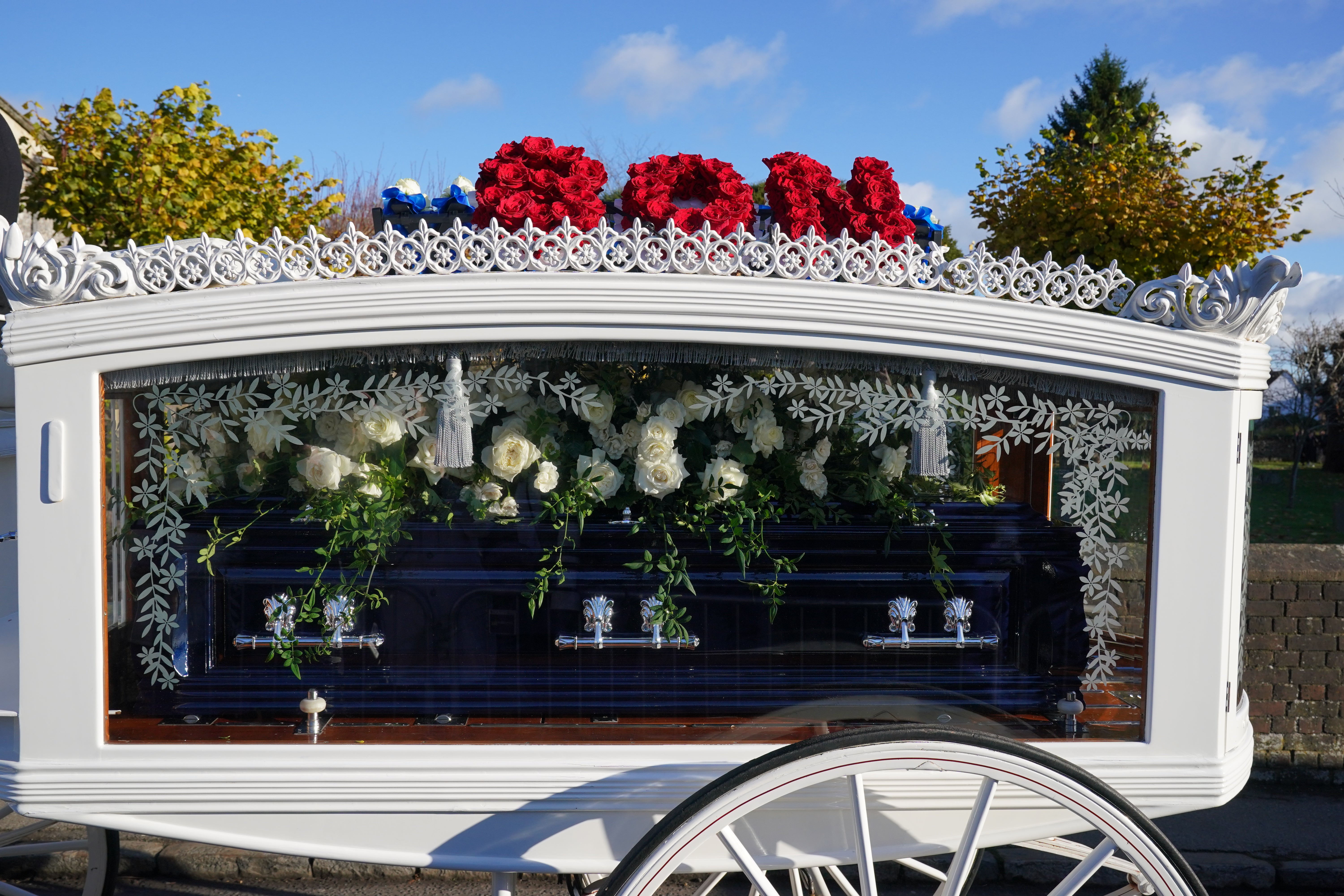 On top of the carriage, there was a red floral tribute which said ‘son’ and a blue tribute which said ‘daddy’, in reference to the son, Bear, that Payne shares with Cheryl Tweedy (Jonathan Brady/PA)