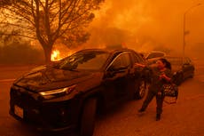 Residentes de Los Ángeles huyen ante el avance de incendio avivado por el viento