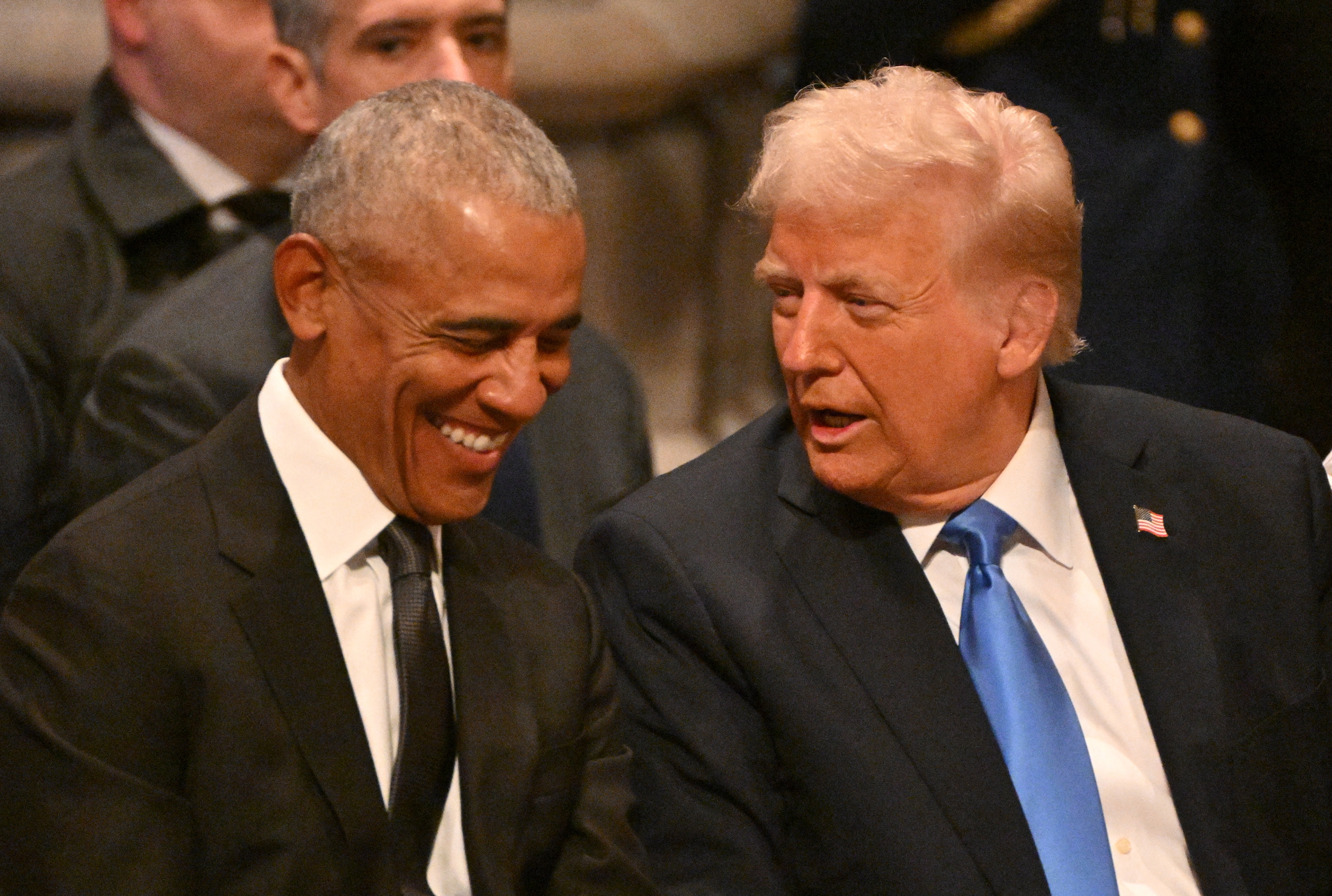 Barack Obama y Donald Trump conversando amablemente durante el funeral de Jimmy Carter a principios de mes, al que también faltó Michelle Obama