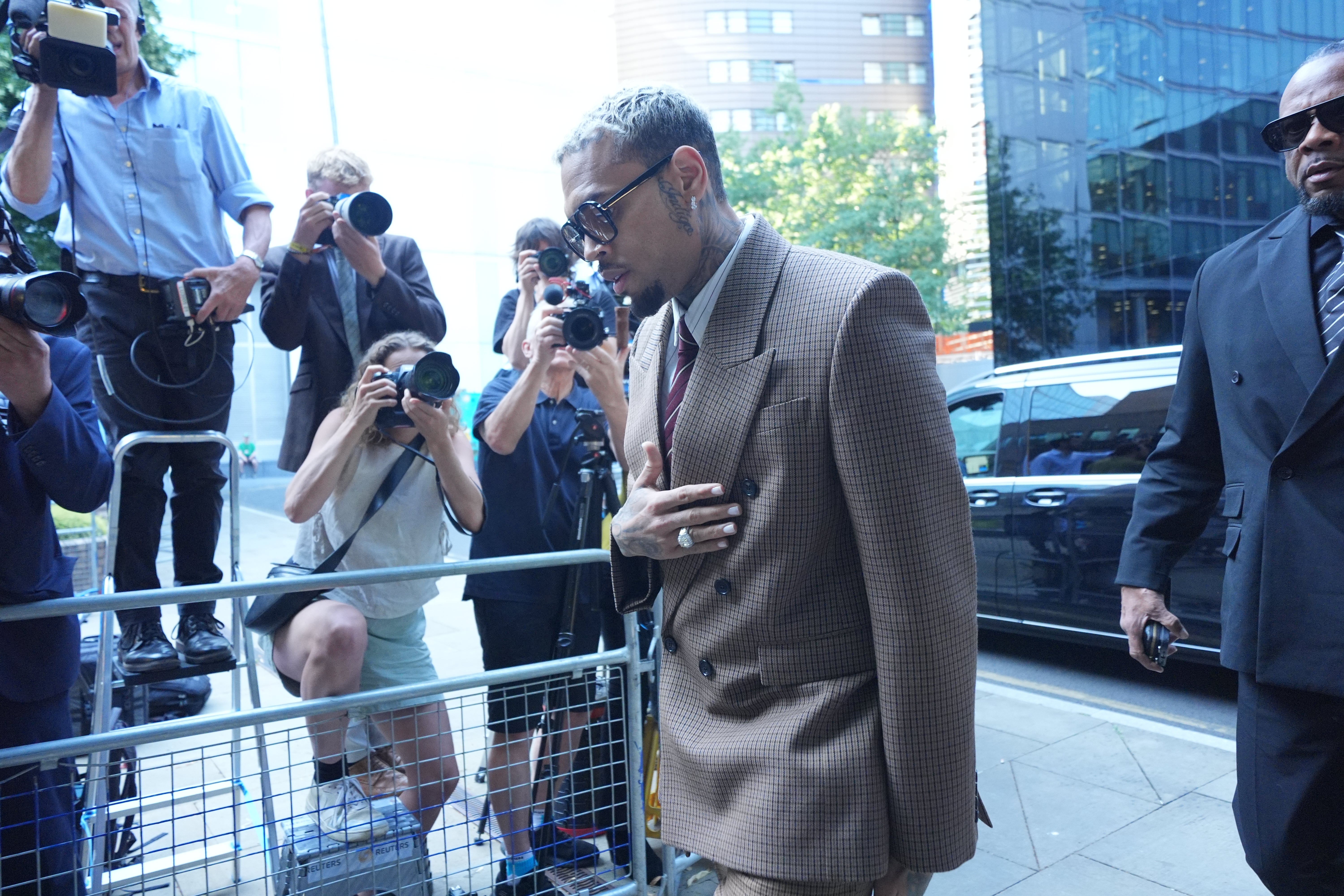 Photographers take pictures as Chris Brown arrives at Southwark Crown Court (Yui Mok/PA)