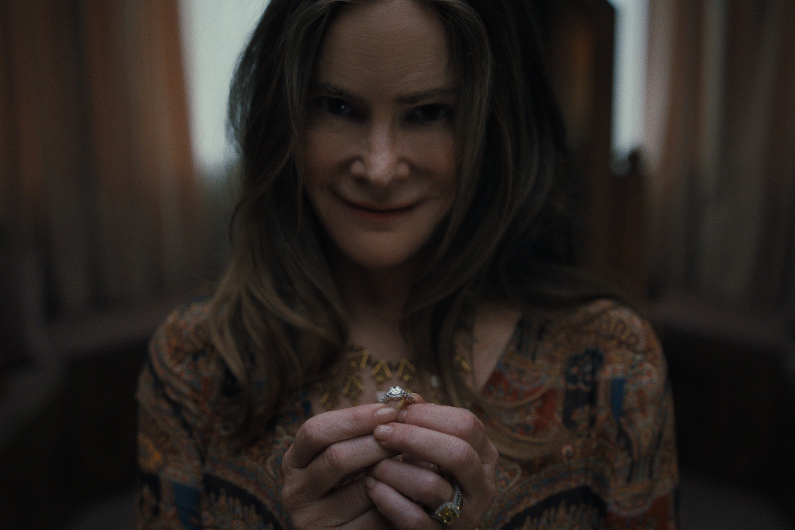 Jennifer Jason Leigh en una escena con poca luz de la película de Netflix ‘Algo terrible está a punto de suceder’