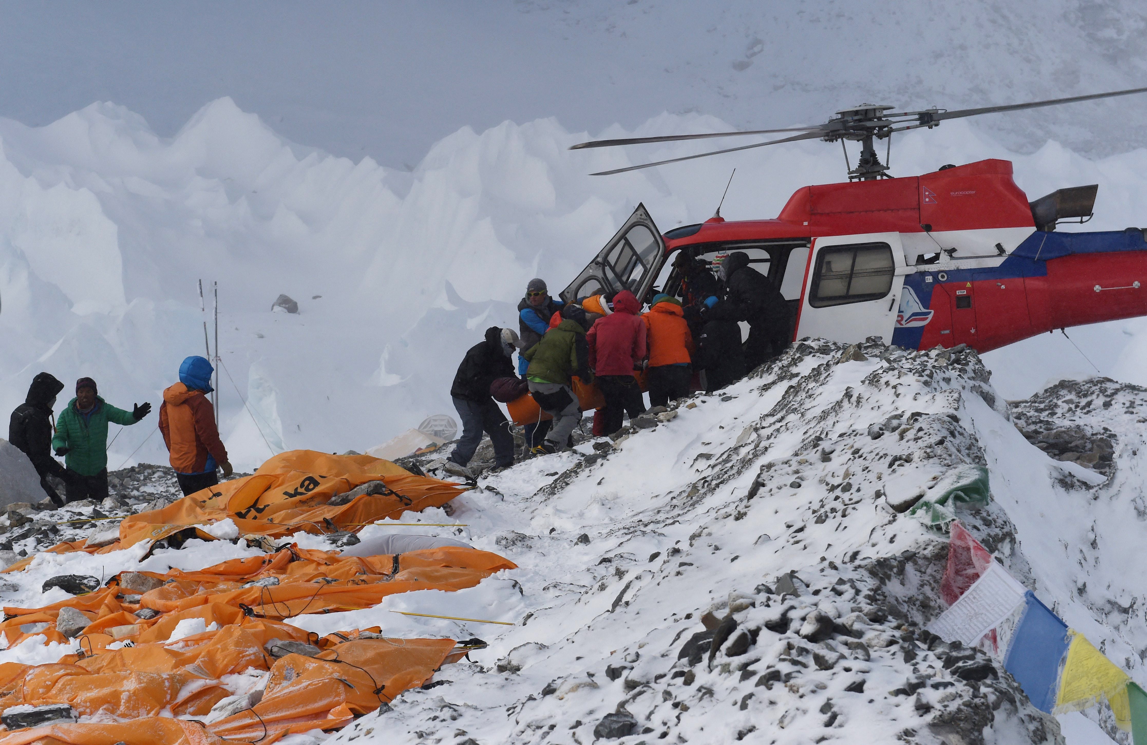 <p>Una persona herida es trasladada a un helicóptero de rescate en el campamento base del Everest el 26 de abril de 2015, un día después de la avalancha provocada por un terremoto que devastó el lugar  </p>