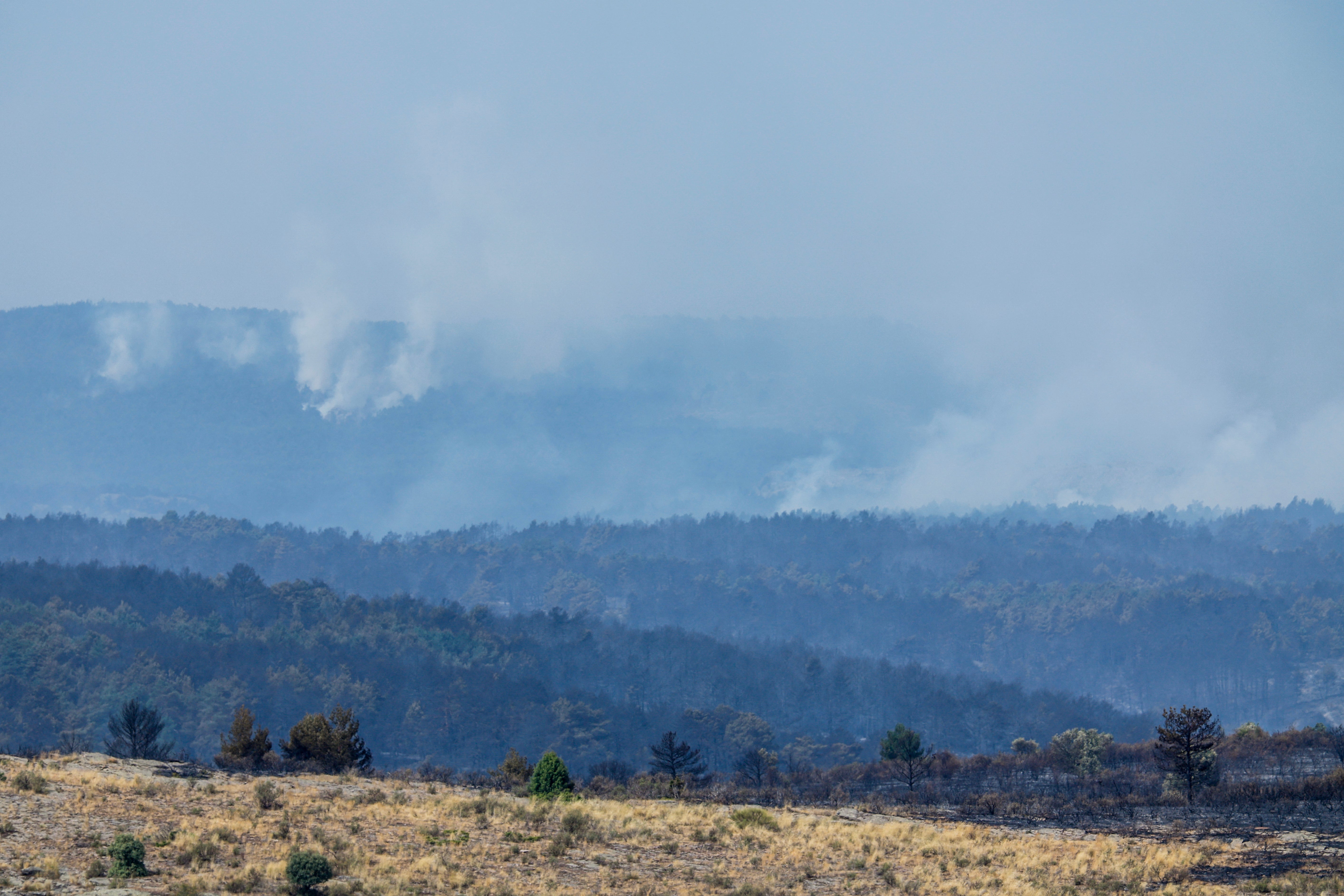 Se observa el humo de un incendio forestal cerca de la localidad de Albendiego, en la provincia de Guadalajara, al norte de Madrid