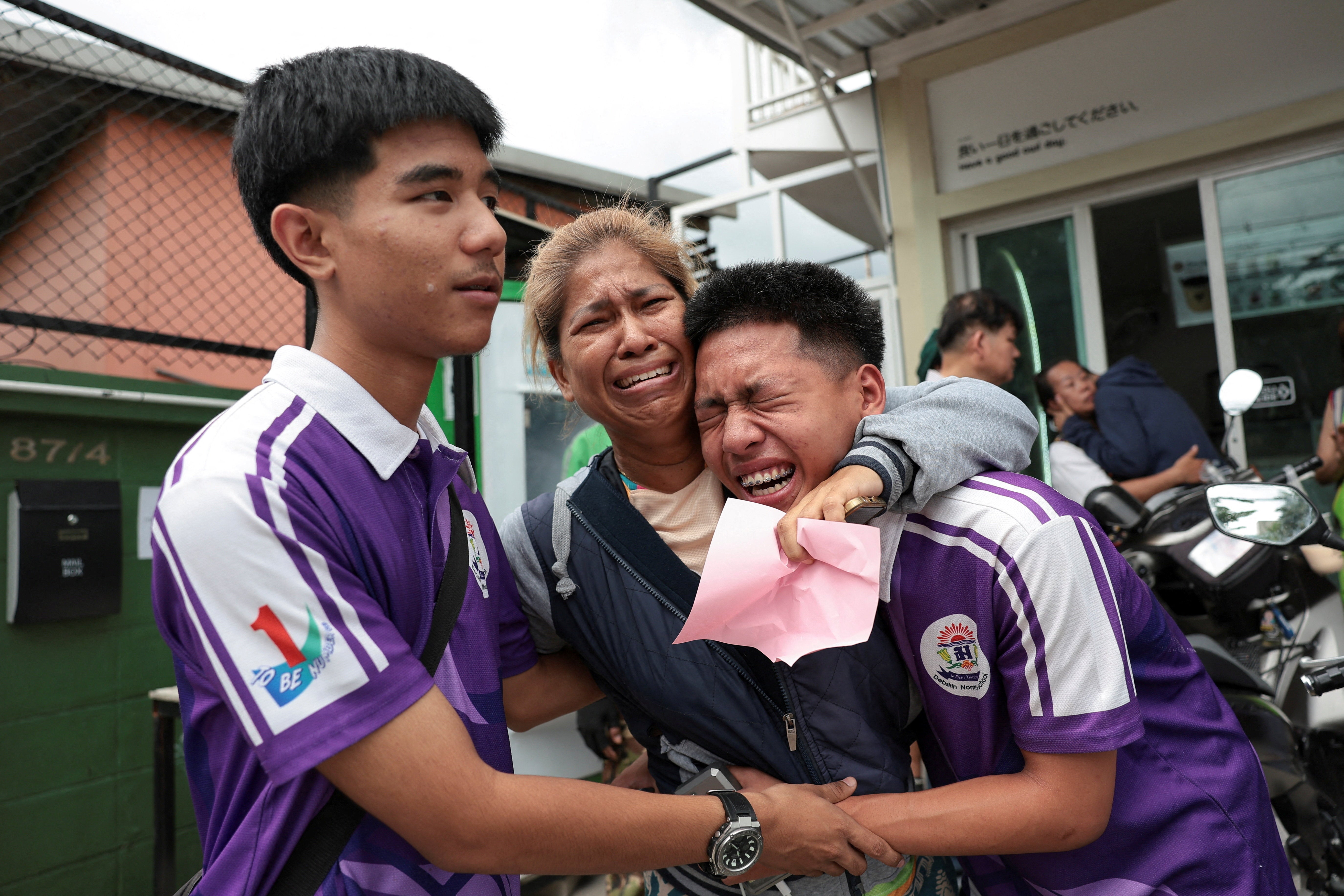 <p>Los alumnos se reencuentran con un familiar tras ser evacuados de la escuela Debsirin Nonthaburi</p>