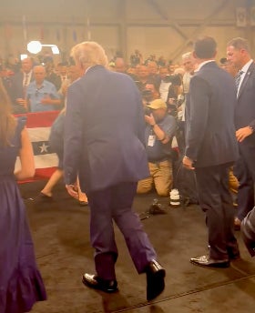 Social media users are speculating about the oddly shaped bulge seen under the bottom of President Donald Trump’s suit jacket