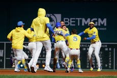 Eli White se desliza de cabeza para anotar la carrera del triunfo de Medias Rojas, 3-2 ante Gigantes