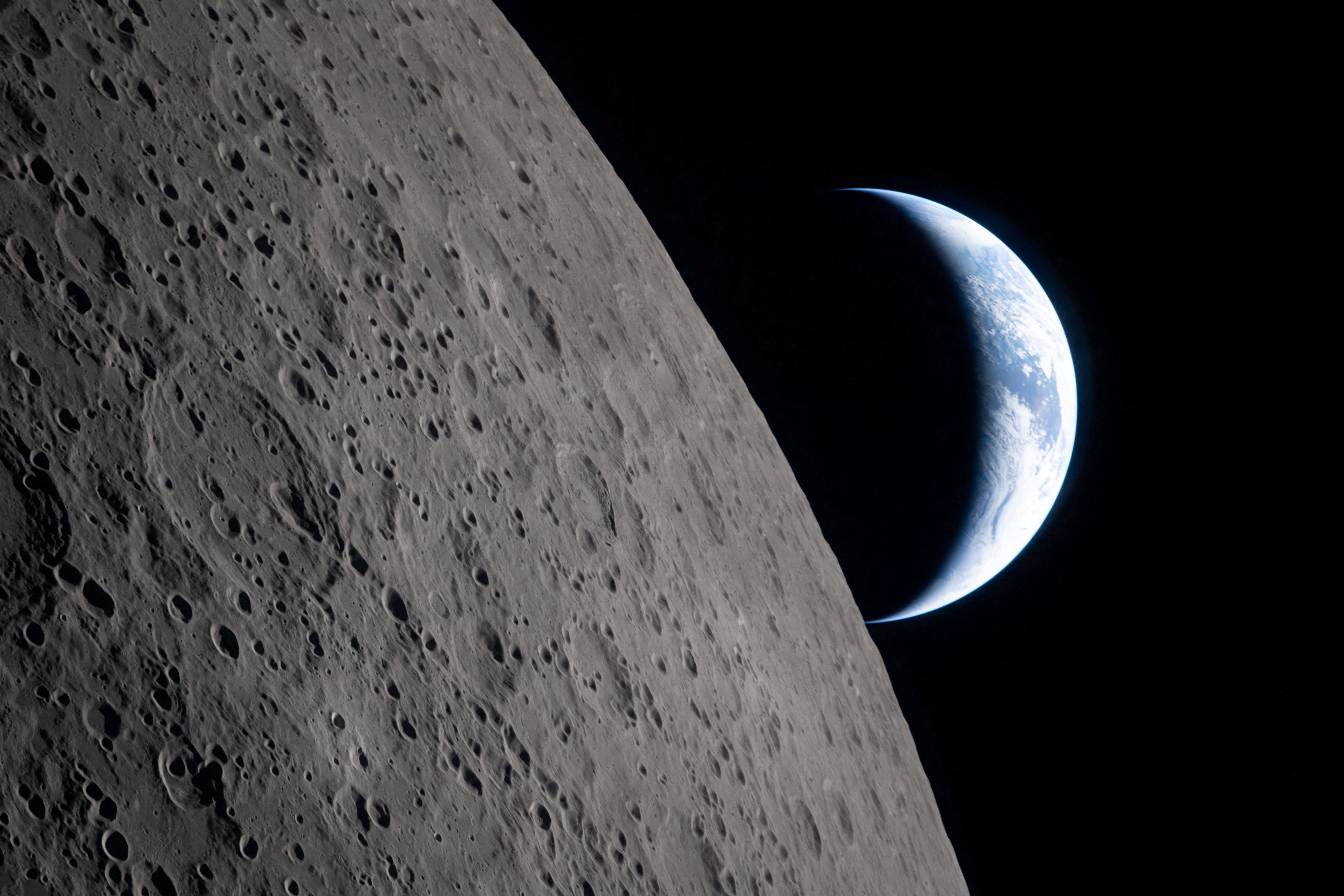 Una vista de la Tierra, parcialmente oculta por la Luna, fotografiada por la tripulación de Artemis II a través de la ventanilla de la nave espacial Orión del 6 de abril de 2026
