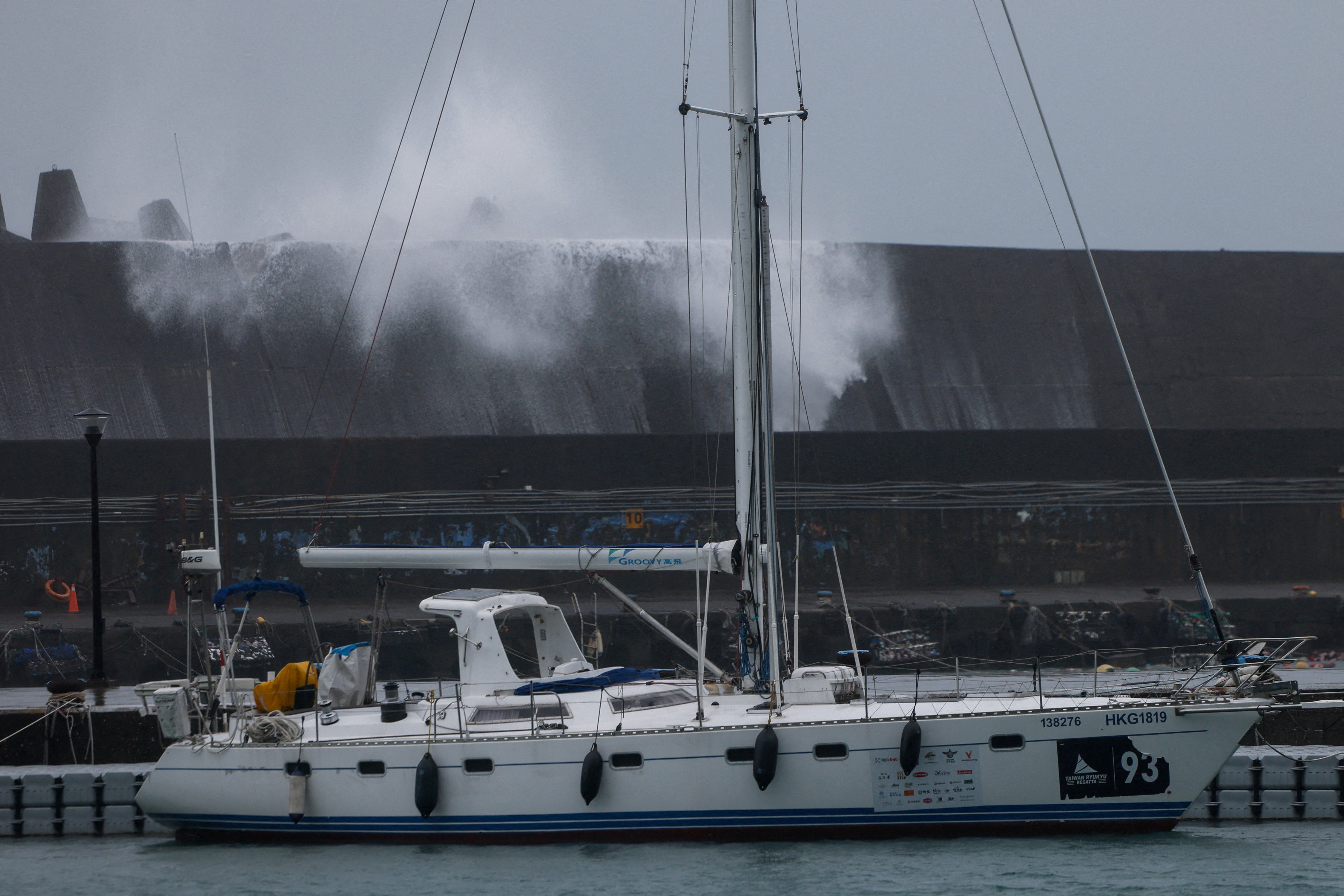 Un velero permanece amarrado cerca de un rompeolas mientras las olas generadas por el tifón Champi golpean el puerto pesquero de Badouzi, en Keelung, Taiwán, el 23 de octubre de 2026