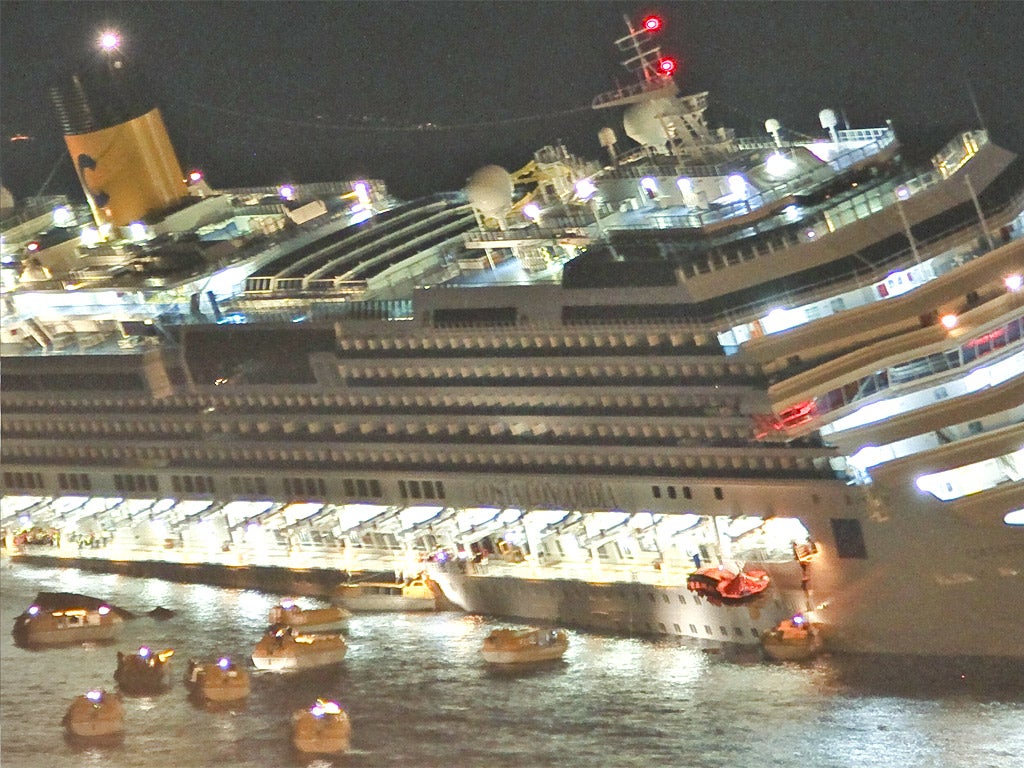 Algunos de los 4.200 pasajeros huyen en botes salvavidas después de que el Costa Concordia encallara frente a Isola del Giglio, en Italia, y se le abriera una gran brecha en el casco